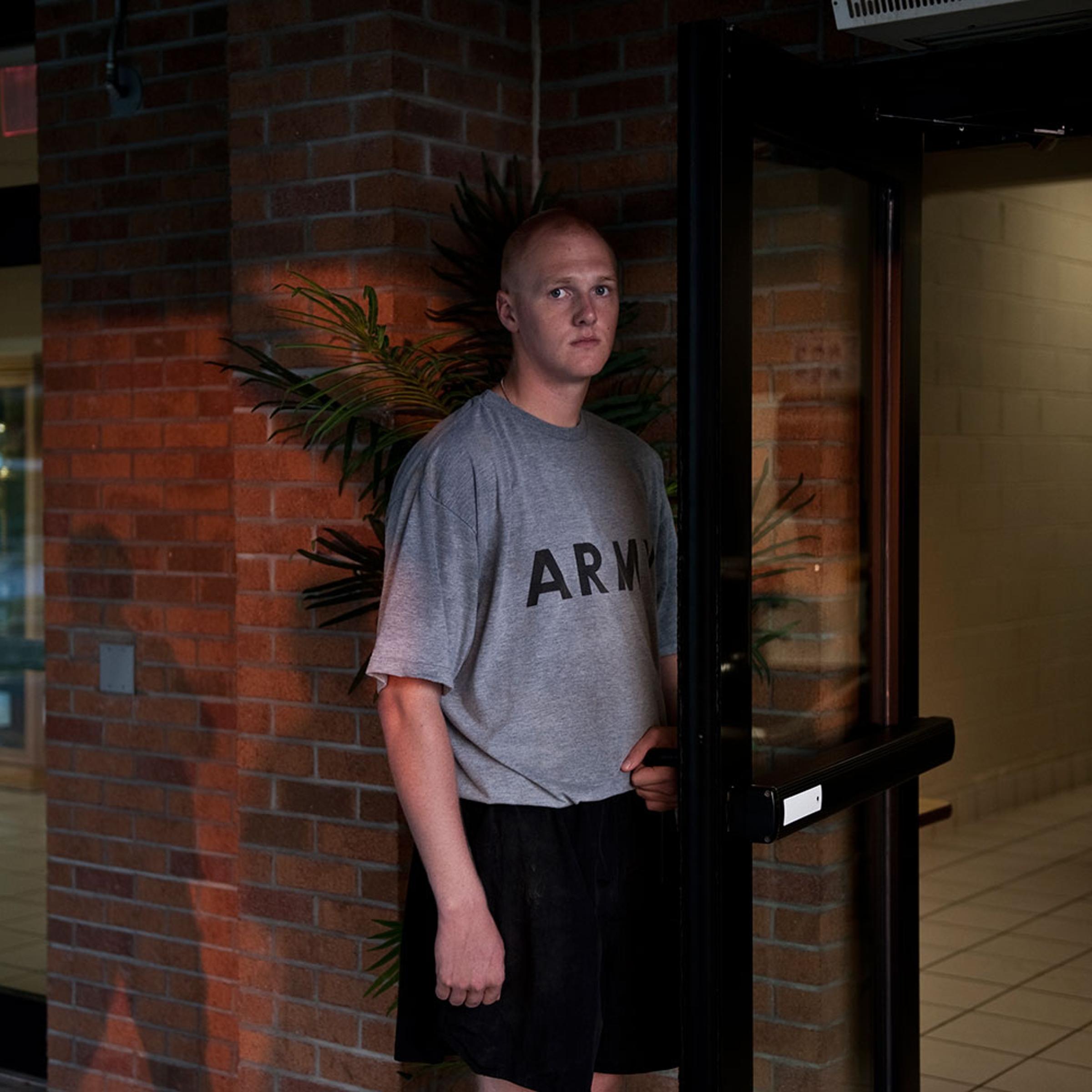 A recruit holds open the door to the mess hall during breakfast hours. Sept. 1, 2011.