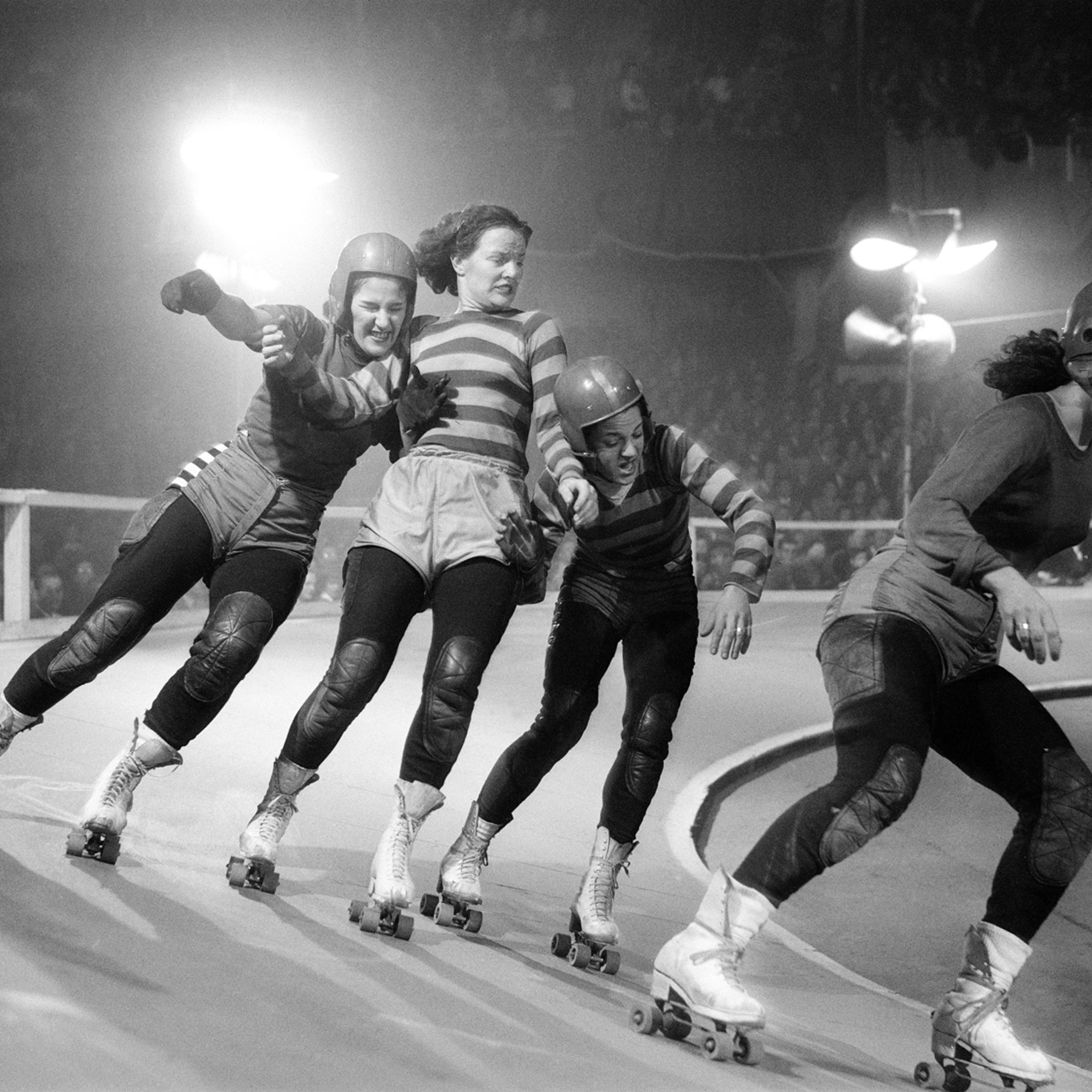 A skillful shoulder block thrown by 'Fuzzy' Buchek (left) foils an attempt by Vivian Johnson (center) to slip between two skaters and start a jam. Blocking and checking are both legal tactics under Derby rules.