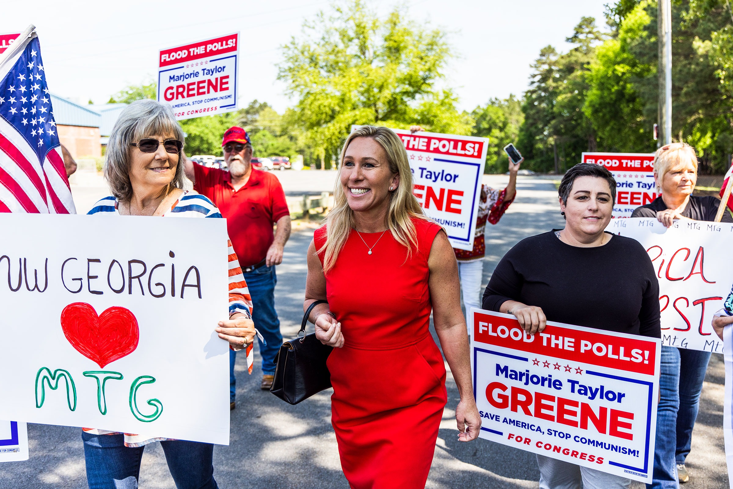 Marjorie Taylor Greene walks with supporters to cast her primary ballot in Rome, Ga., on the first day of early voting.