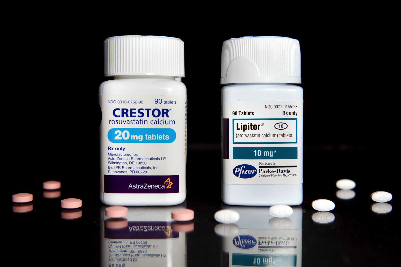 Cholesterol drugs, Crestor, left, manufactured by AstraZeneca Plc, and Lipitor, manufactured by Pfizer Inc., are arranged for a photrograph at New London Pharmacy in New York, U.S., on Tuesday, April 6, 2010.