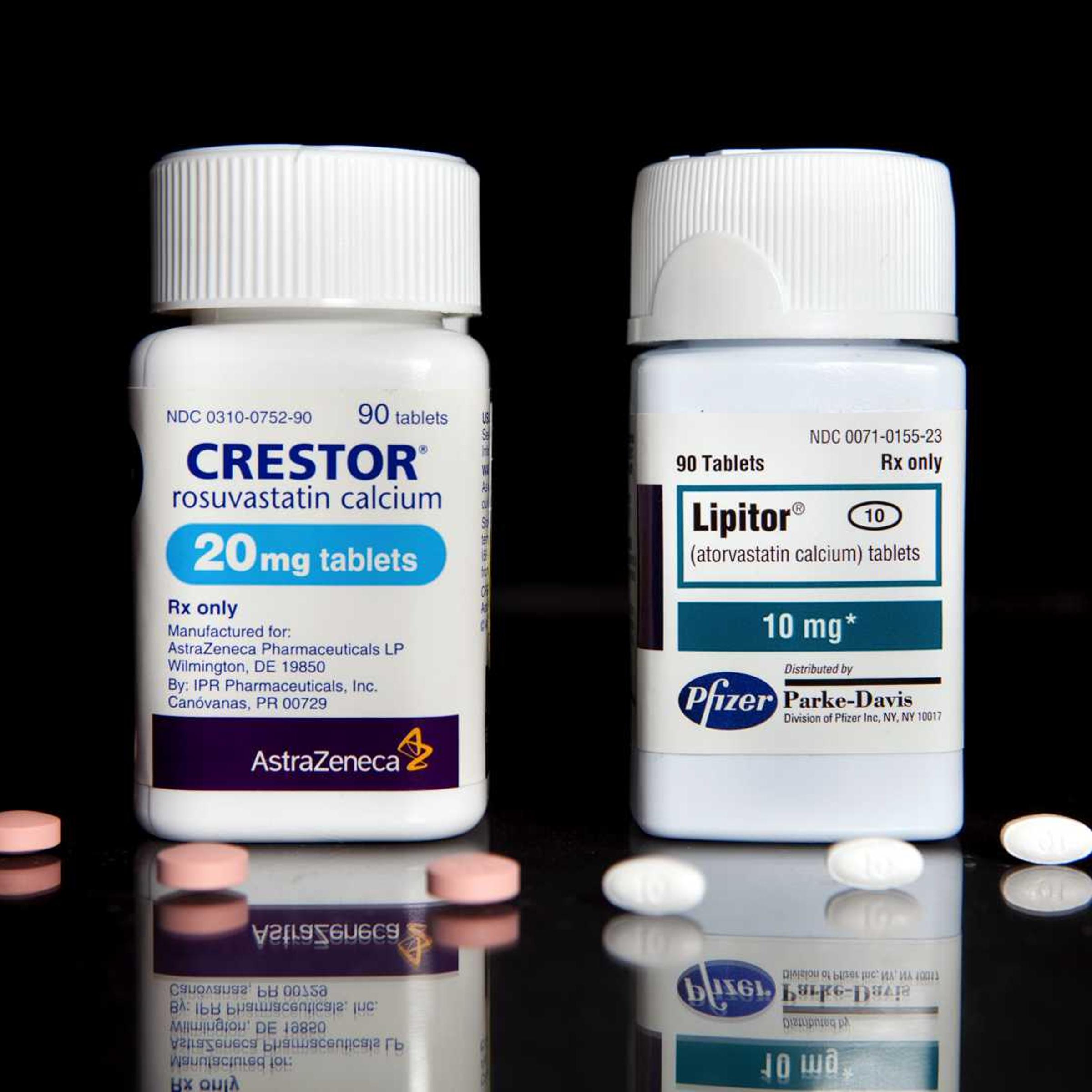 Cholesterol drugs, Crestor, left, manufactured by AstraZeneca Plc, and Lipitor, manufactured by Pfizer Inc., are arranged for a photrograph at New London Pharmacy in New York, U.S., on Tuesday, April 6, 2010.