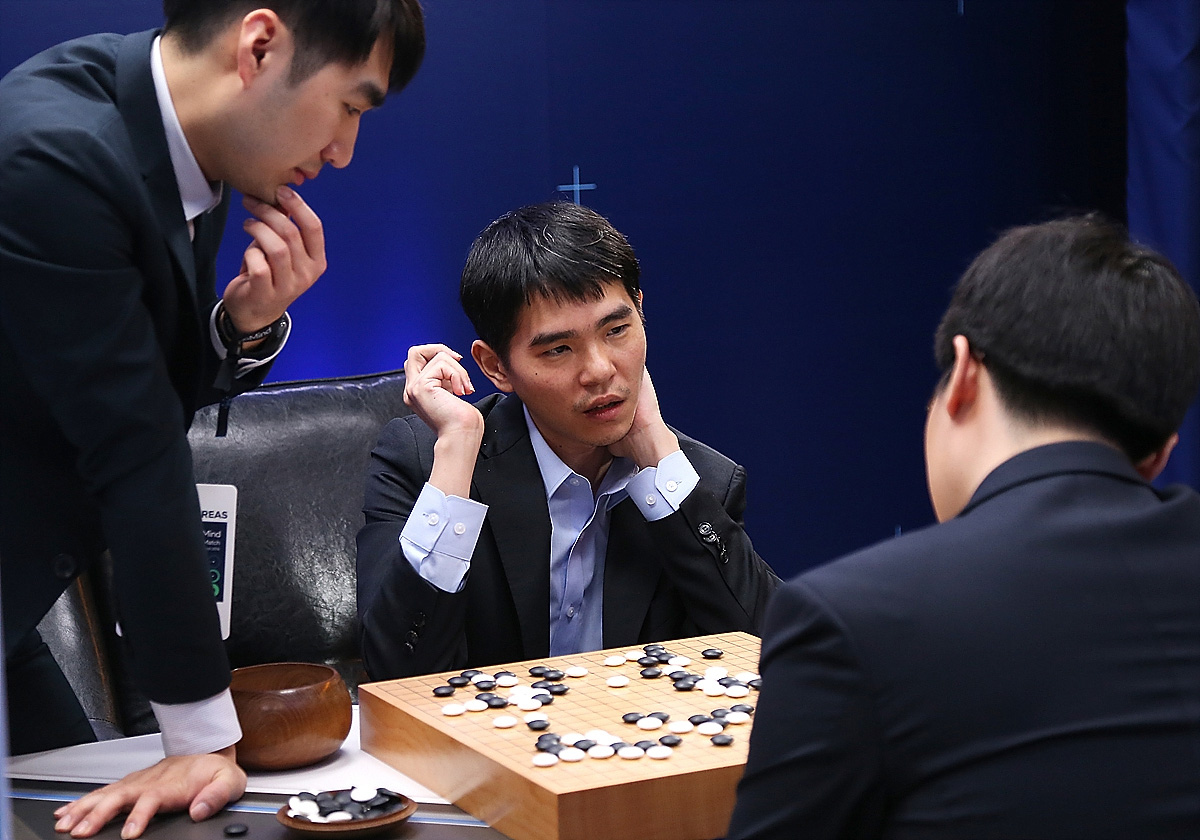 In this handout image provided by Google, South Korean professional Go player Lee Se-Dol reviews the match with other professional Go players after the fourth match against Google's artificial intelligence program, AlphaGo, during the Google DeepMind Cha