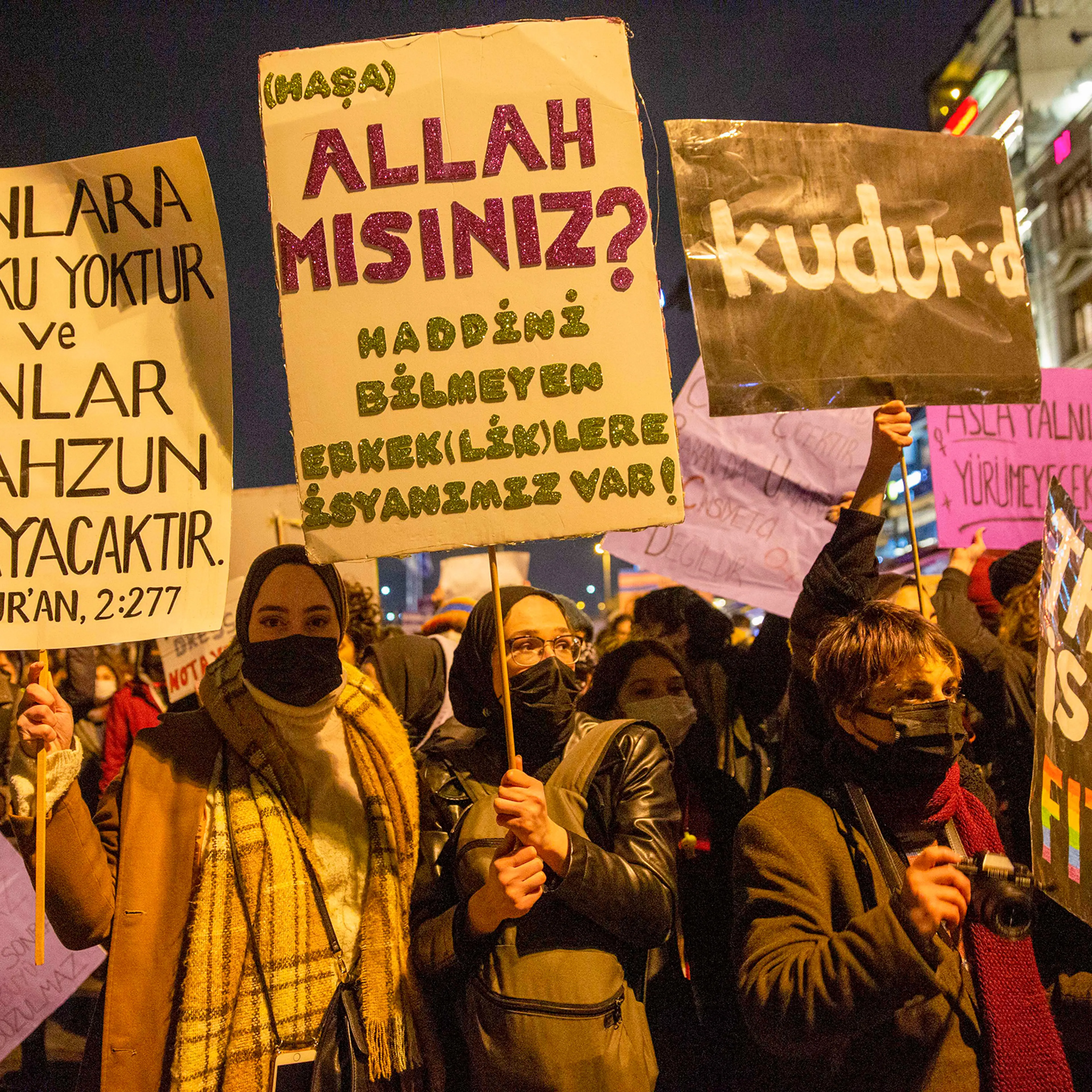 Women at a feminist night march hold posters reading, “Are you God? We’re rebelling against unrestrained men and masculinity,” and, “On them shall be no fear, nor shall they grieve,” Quran verse 2:277