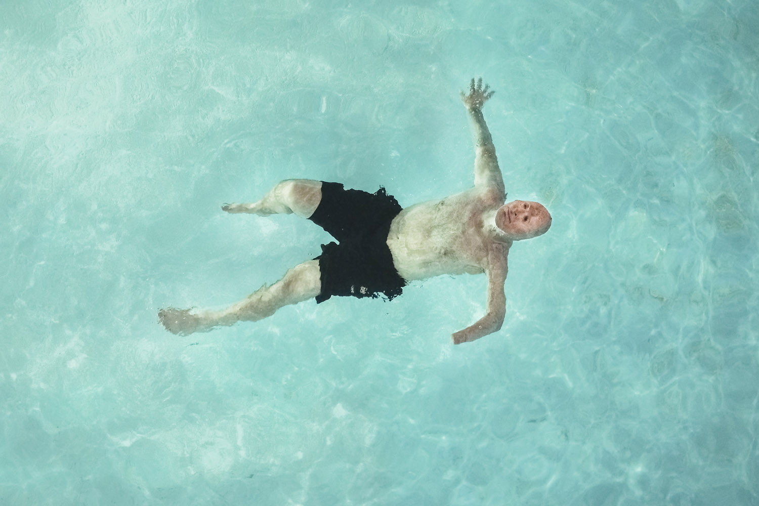 2013. Humble, TX. USA. Bobby swims at a Motel 6 after visiting the father of Rodney McCandless. Rodney was killed in the IED explosion that injured Bobby. For years McCandless's family didn't know that anyone had survived the attack until Bobby was able 
