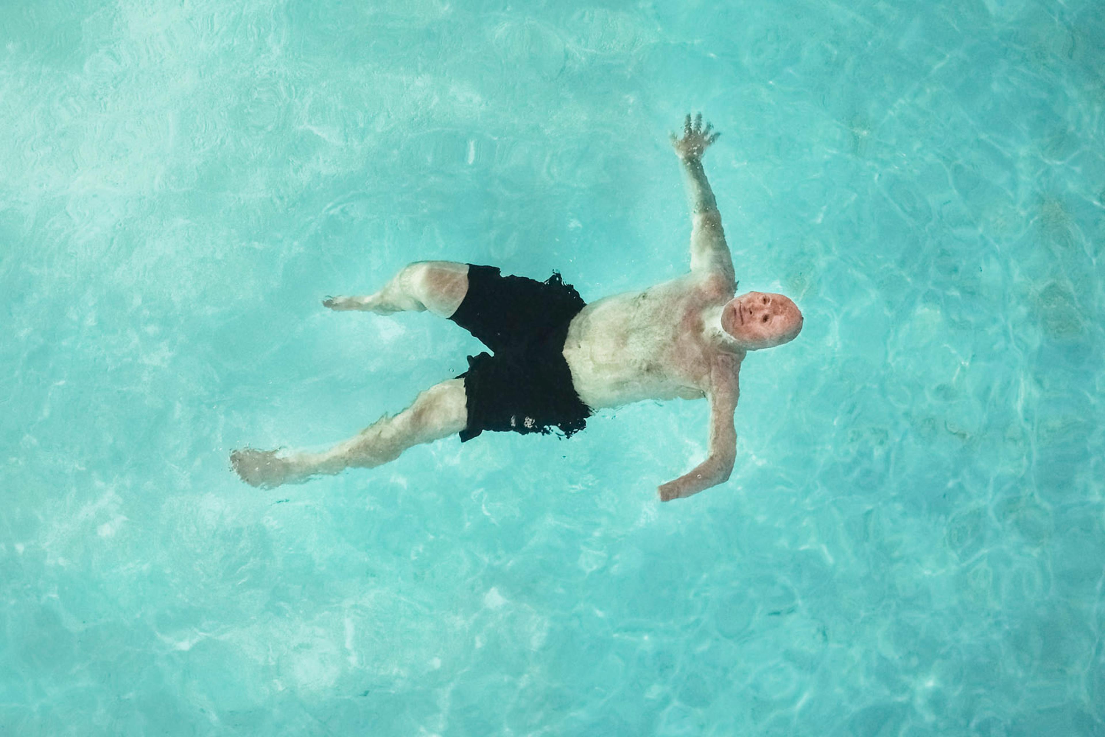 2013. Humble, TX. USA. Bobby swims at a Motel 6 after visiting the father of Rodney McCandless. Rodney was killed in the IED explosion that injured Bobby. For years McCandless's family didn't know that anyone had survived the attack until Bobby was able