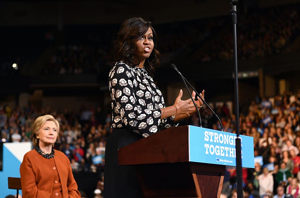First Lady Michelle Obama speaks as Democratic presidential nominee Hillary Clinton listens during a campaign rally in Winston-Salem, North Carolina on October 27, 2016.