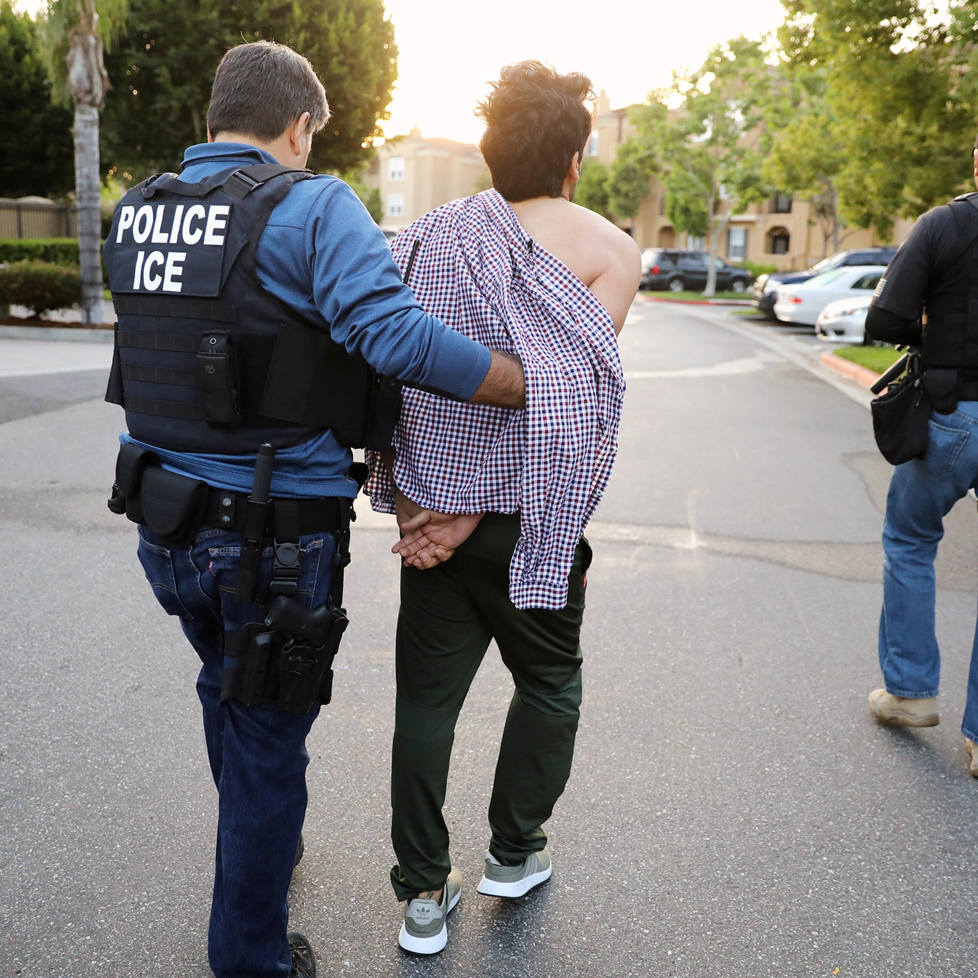 An Iranian immigrant is led away in California in May