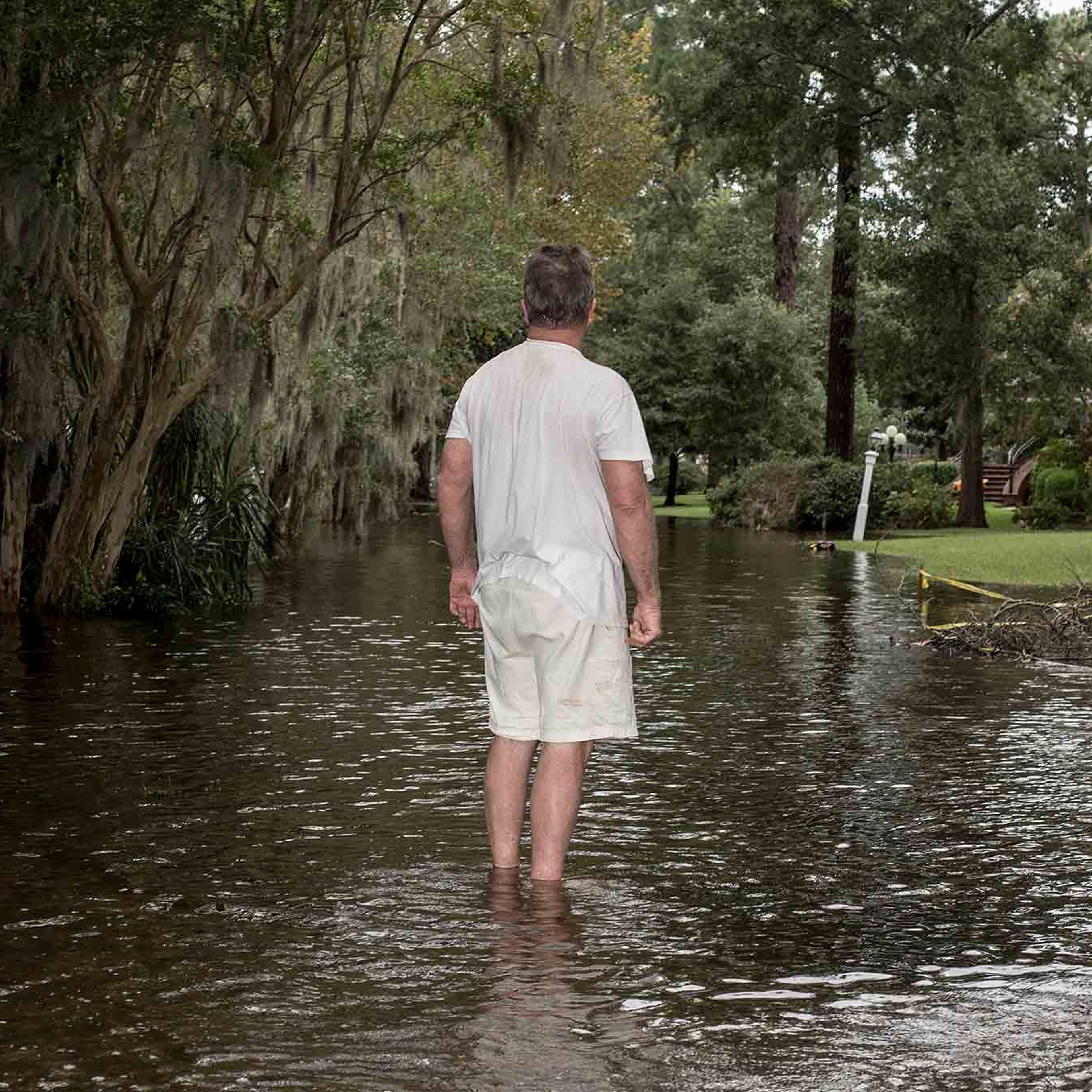 Lee Roy Scott with his dog Bella (right) poses for a portrait while surveying damage to his neighborhood due to storm surge flooding from Hurricane Florence in Washington, N.C. on Saturday, September 15, 2018.CREDIT: Bryan Anselm/Redux for Time