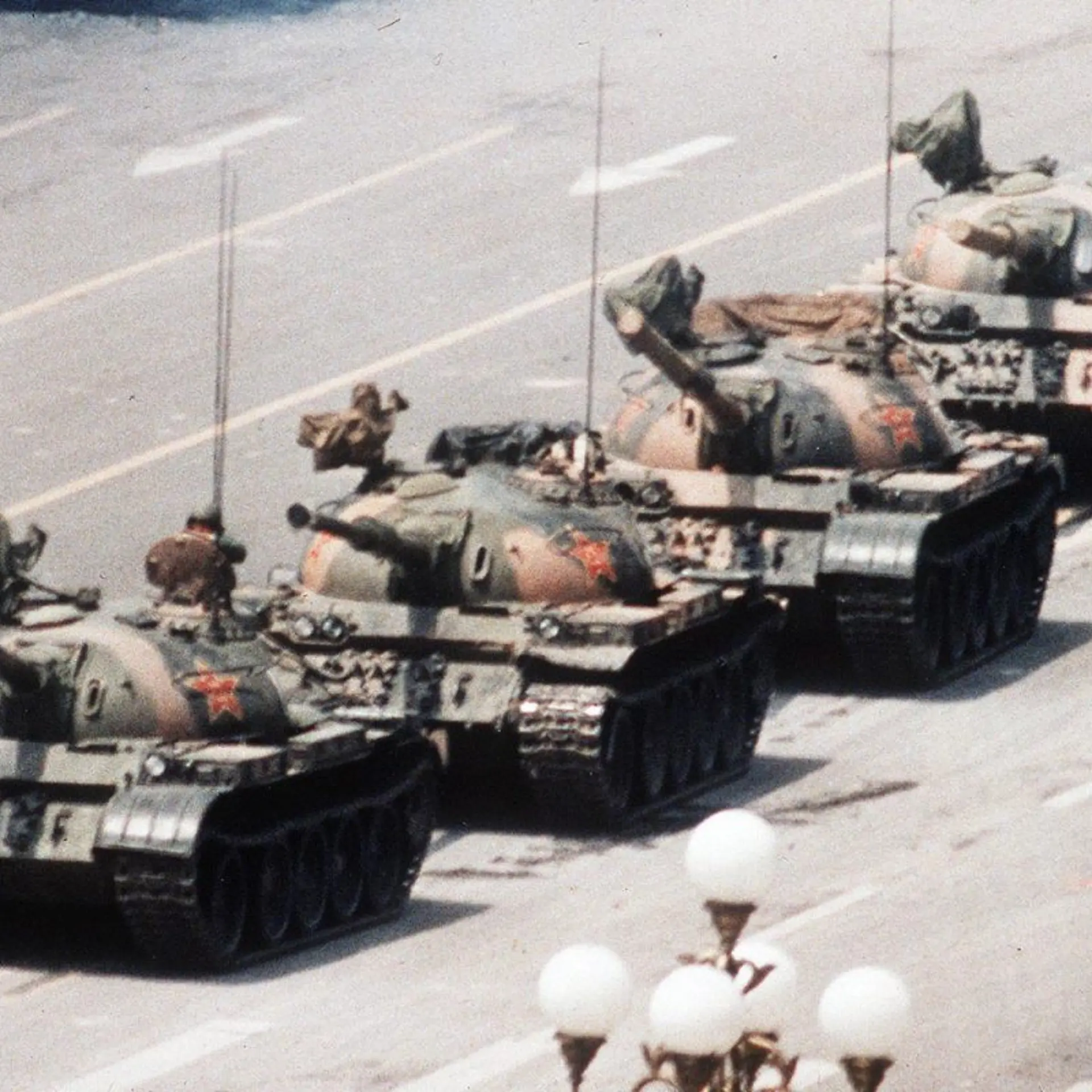 A Chinese man stands alone to block a line of tanks heading east on Beijing's Changan Avenue in Tiananmen Square on June 5, 1989. The man, calling for an end to the recent violence and bloodshed against pro-democracy demonstrators, was pulled away by bystanders, and the tanks continued on their way.