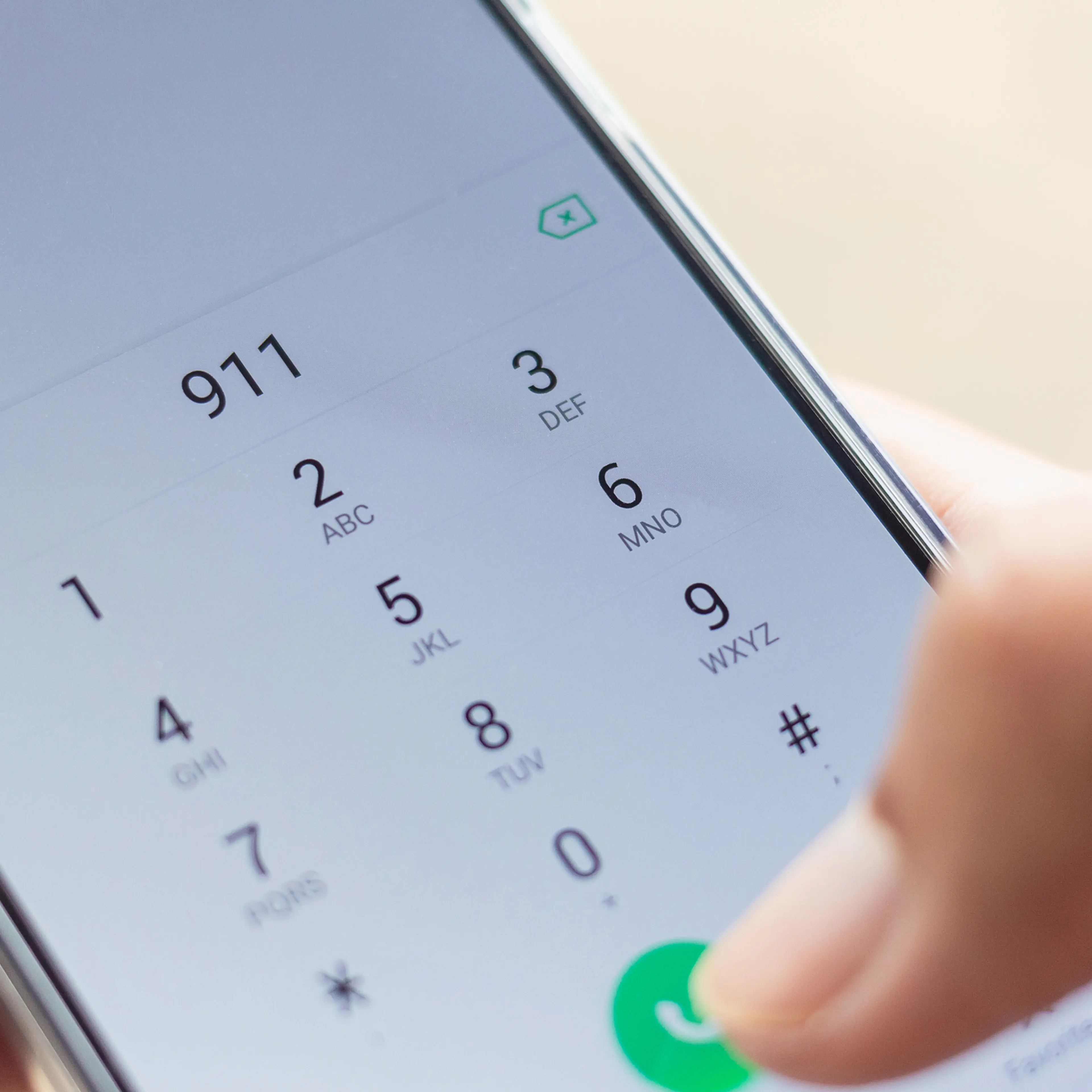 Emergency and urgency, dialing 911 on smartphone screen. Shallow depth of field.