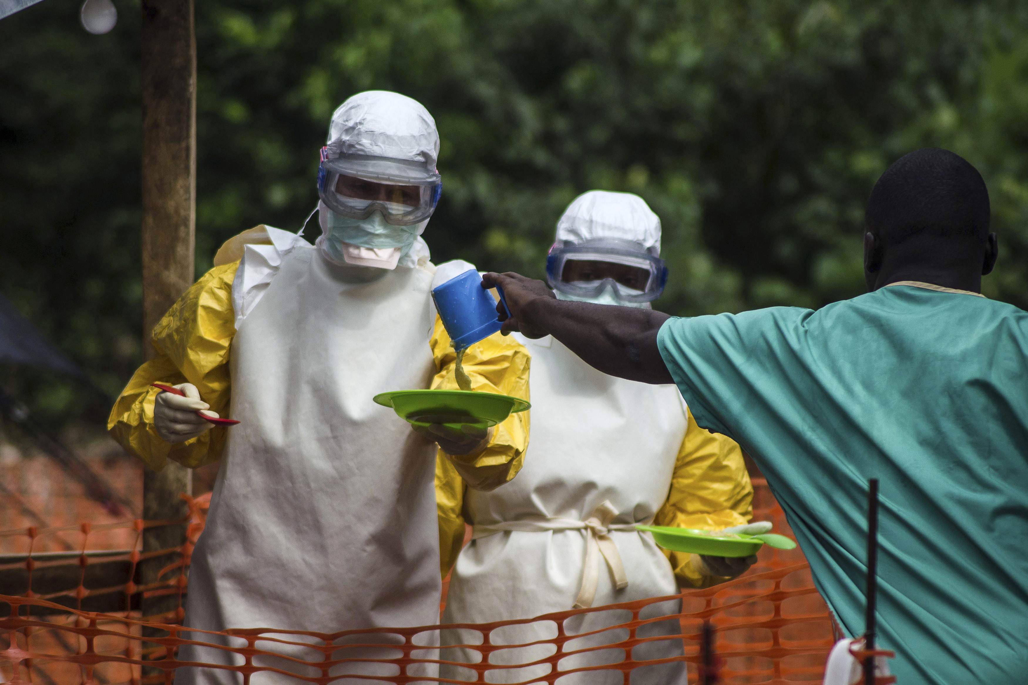 Medical staff working with Medecins sans Frontieres (MSF) prepare to bring food to patients kept in an isolation area at the MSF Ebola treatment centre in Kailahun, Sierra Leone on July 20, 2014.