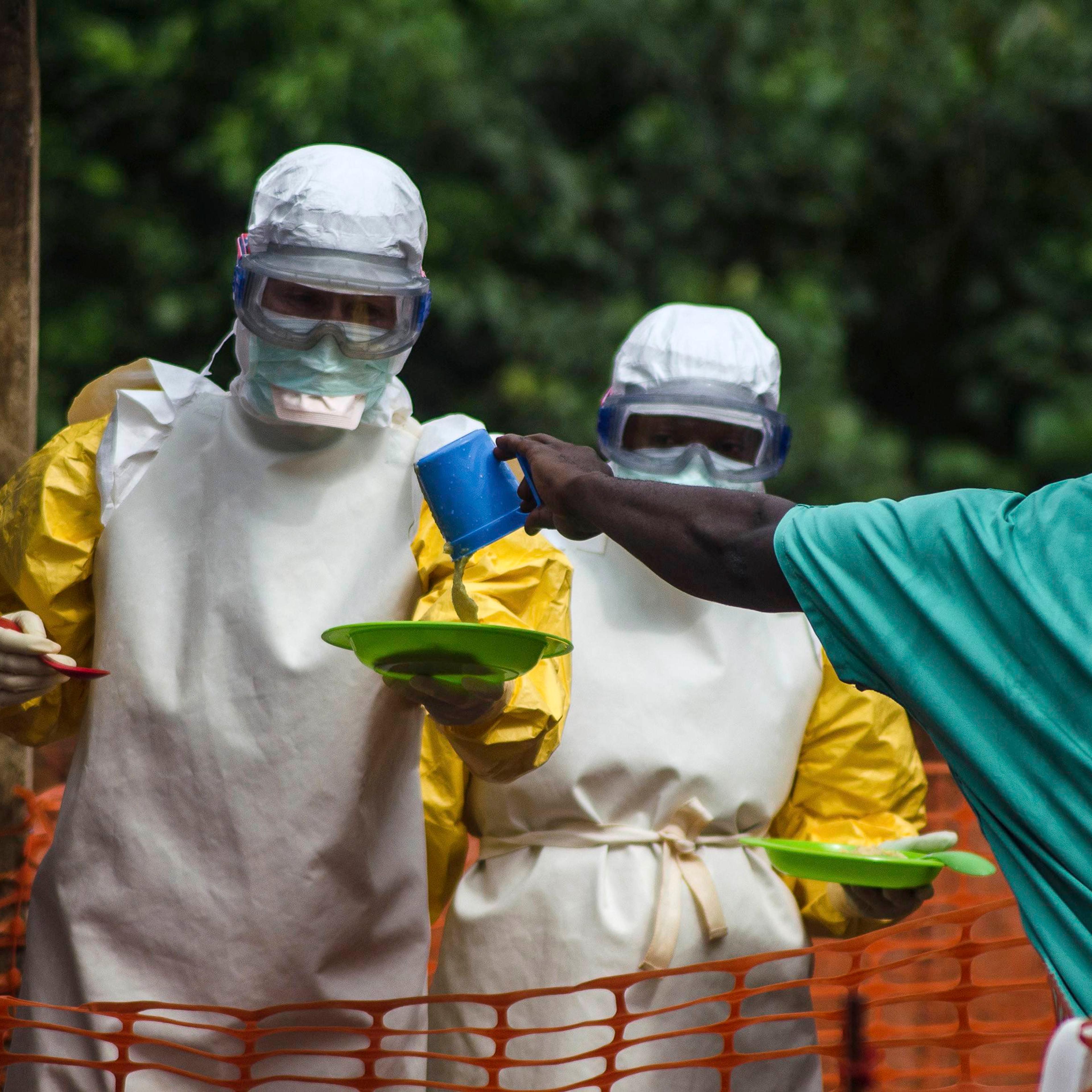 Medical staff working with Medecins sans Frontieres (MSF) prepare to bring food to patients kept in an isolation area at the MSF Ebola treatment centre in Kailahun, Sierra Leone on July 20, 2014.