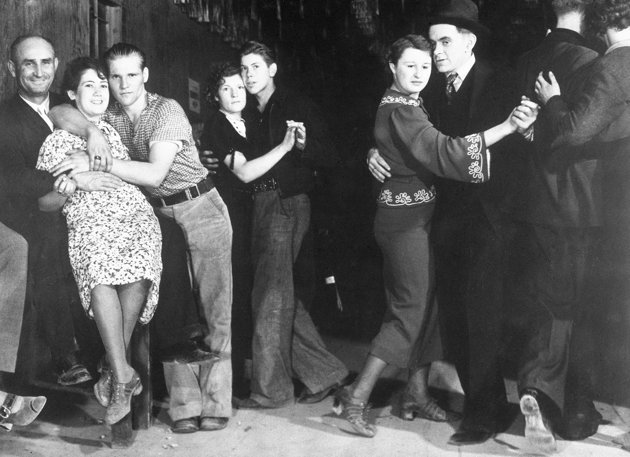 Workers on Montana's Fort Peck Dam blow off steam at night, 1936.