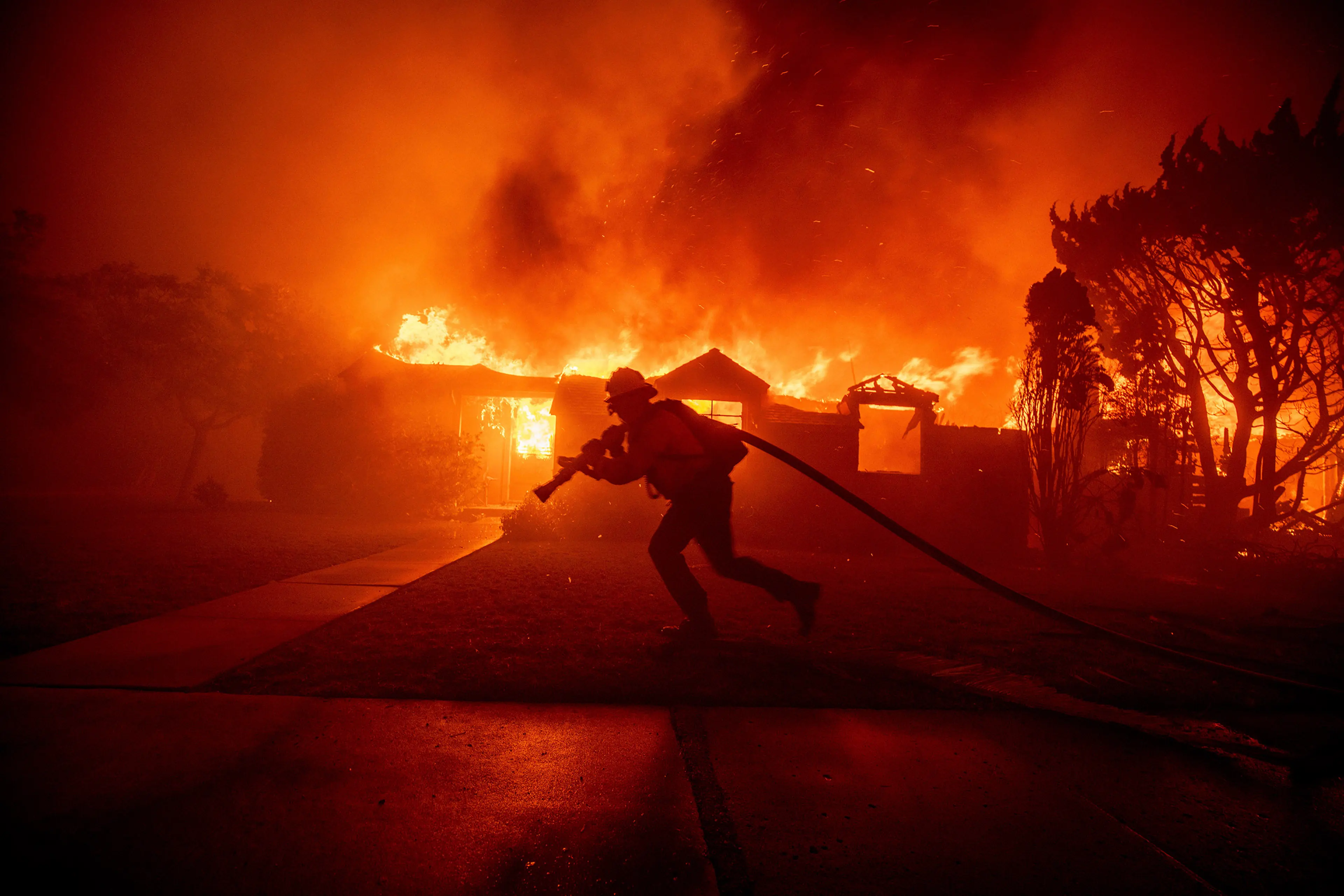 A firefighter moves against the Palisades Fire on Jan. 7