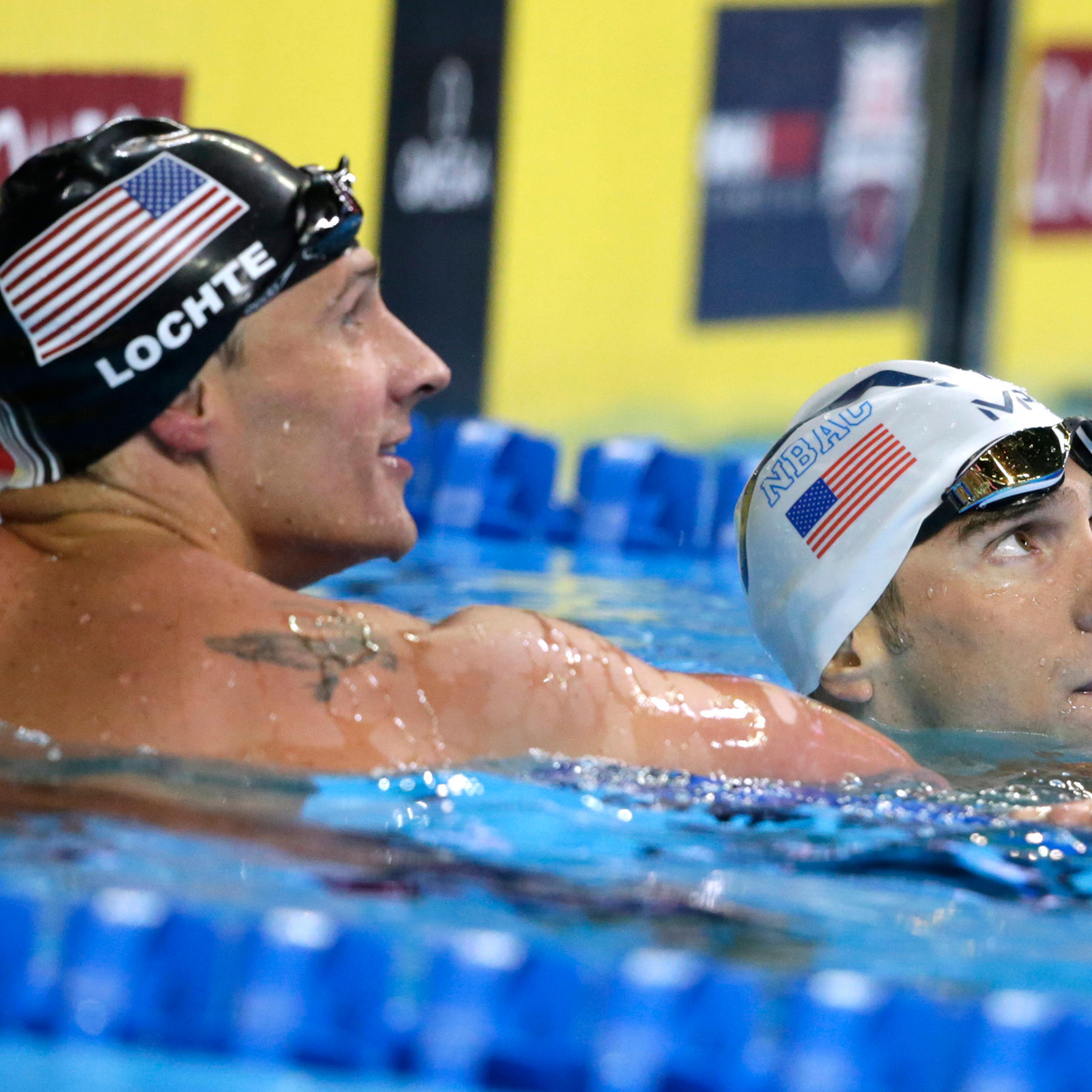 Michael Phelps, right, reacts with Ryan Lochte, left, after winning the men's 200-meter individual medley final at the U.S. Olympic swimming trials, in Omaha, Neb. on July 1, 2016. Lochte finished in second place.