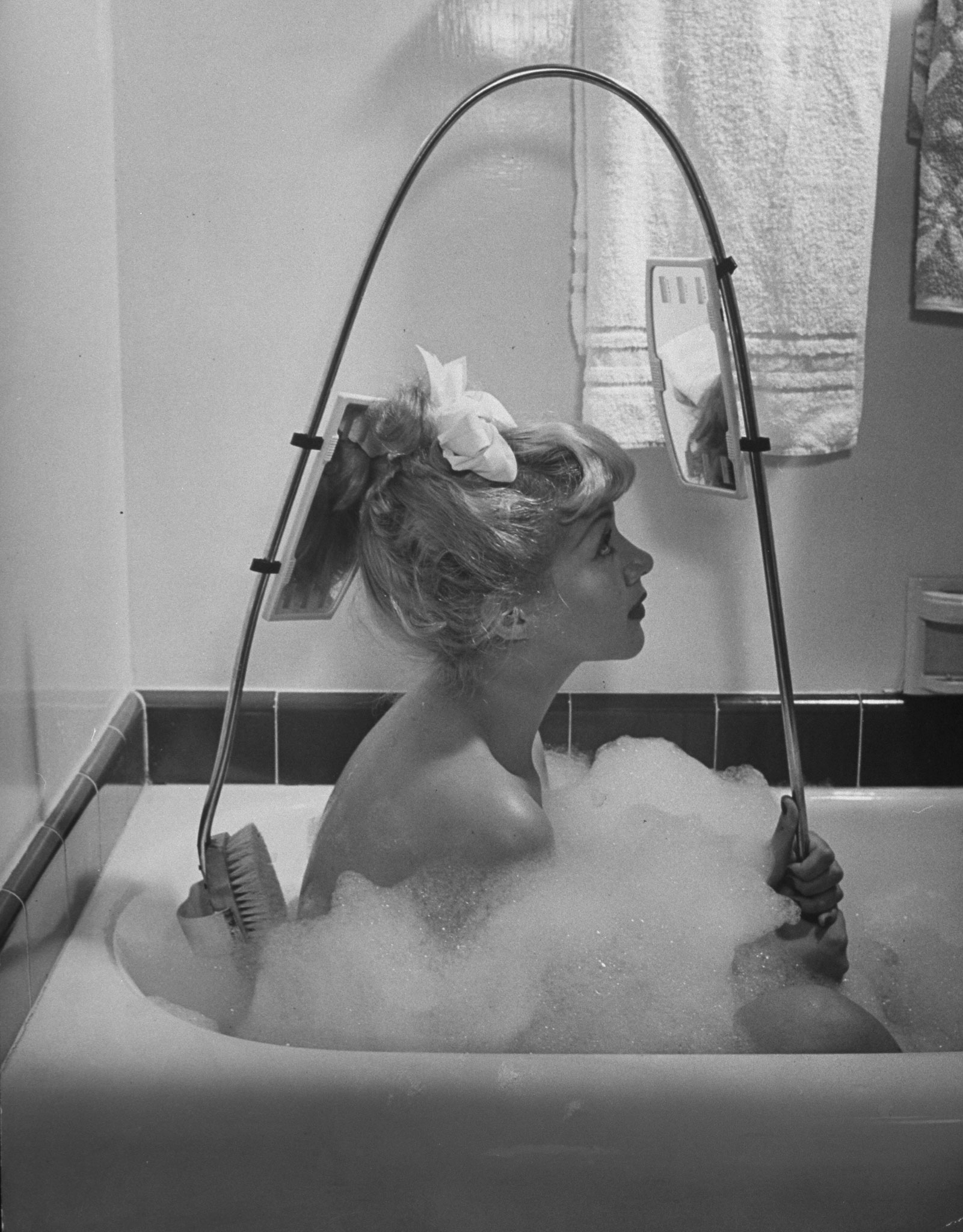 New back brush lets bather see just what she is up to.