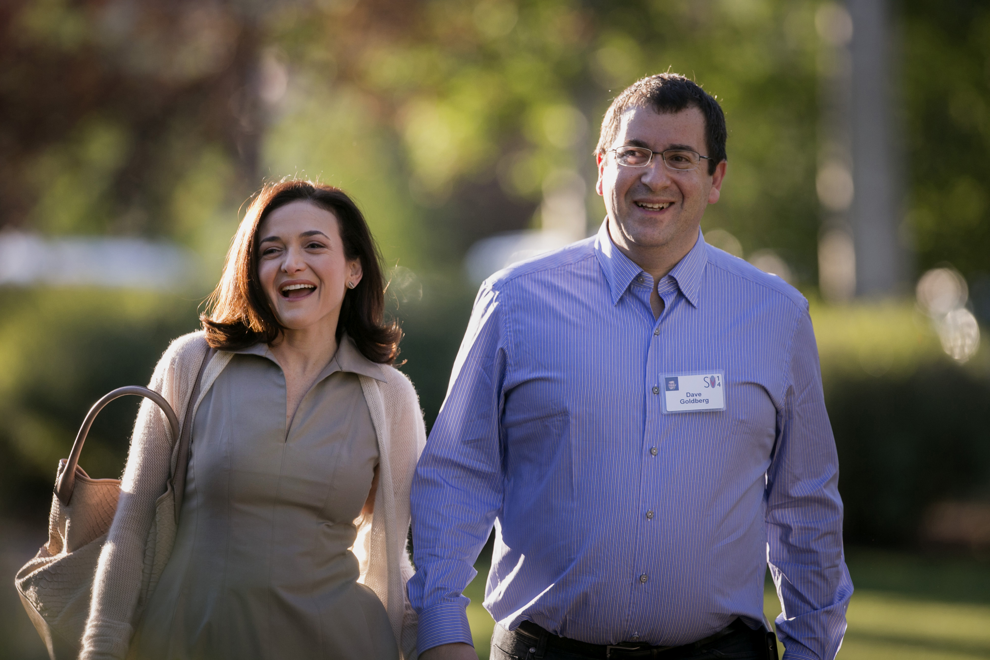 Sheryl Sandberg, chief operating officer of Facebook Inc., left, and her late husband David Goldberg, chief executive officer of SurveyMonkey, arrive to a morning session at the Sun Valley Lodge during the Allen & Co. Media and Technology Conference in S