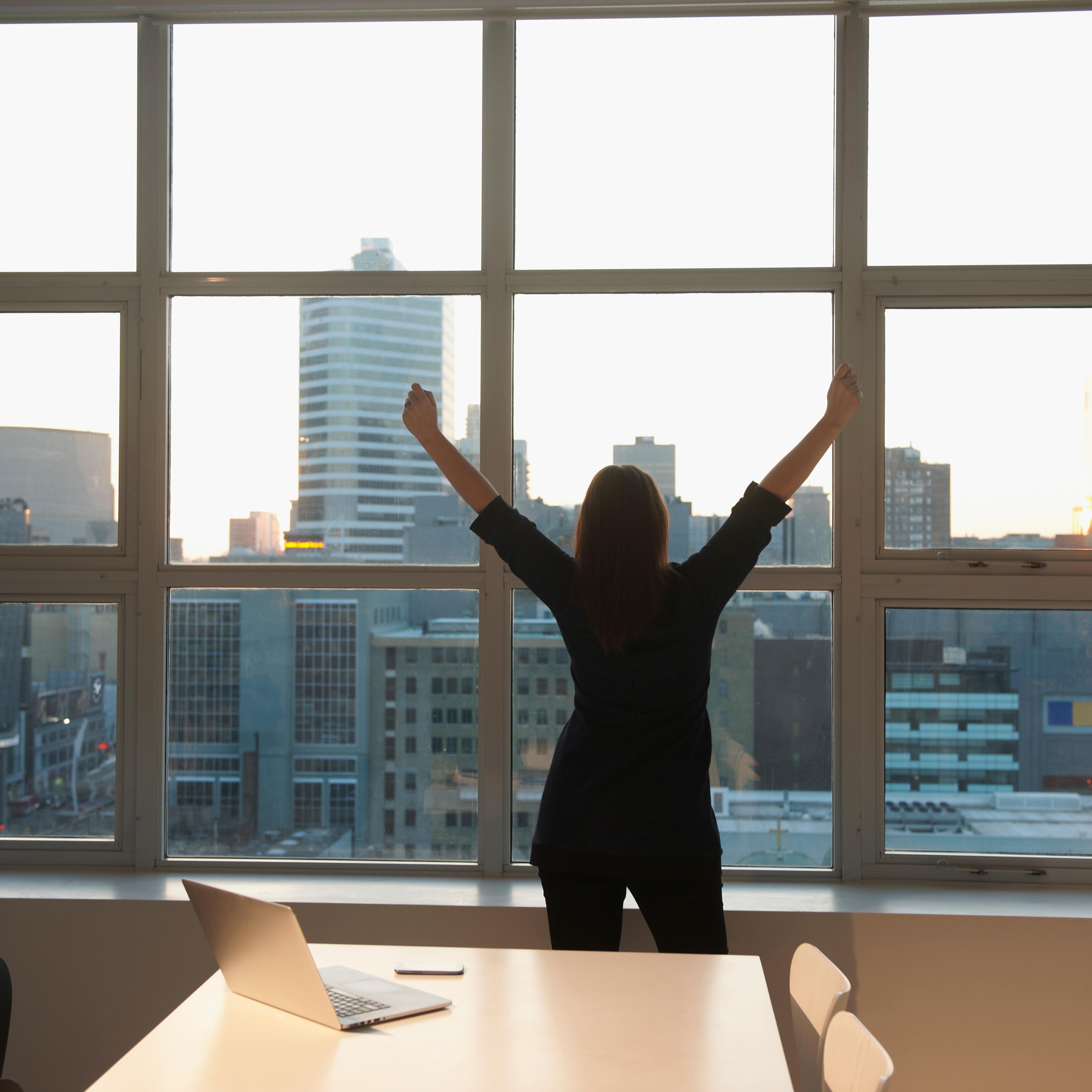 business-woman-arms-raised-rear-view