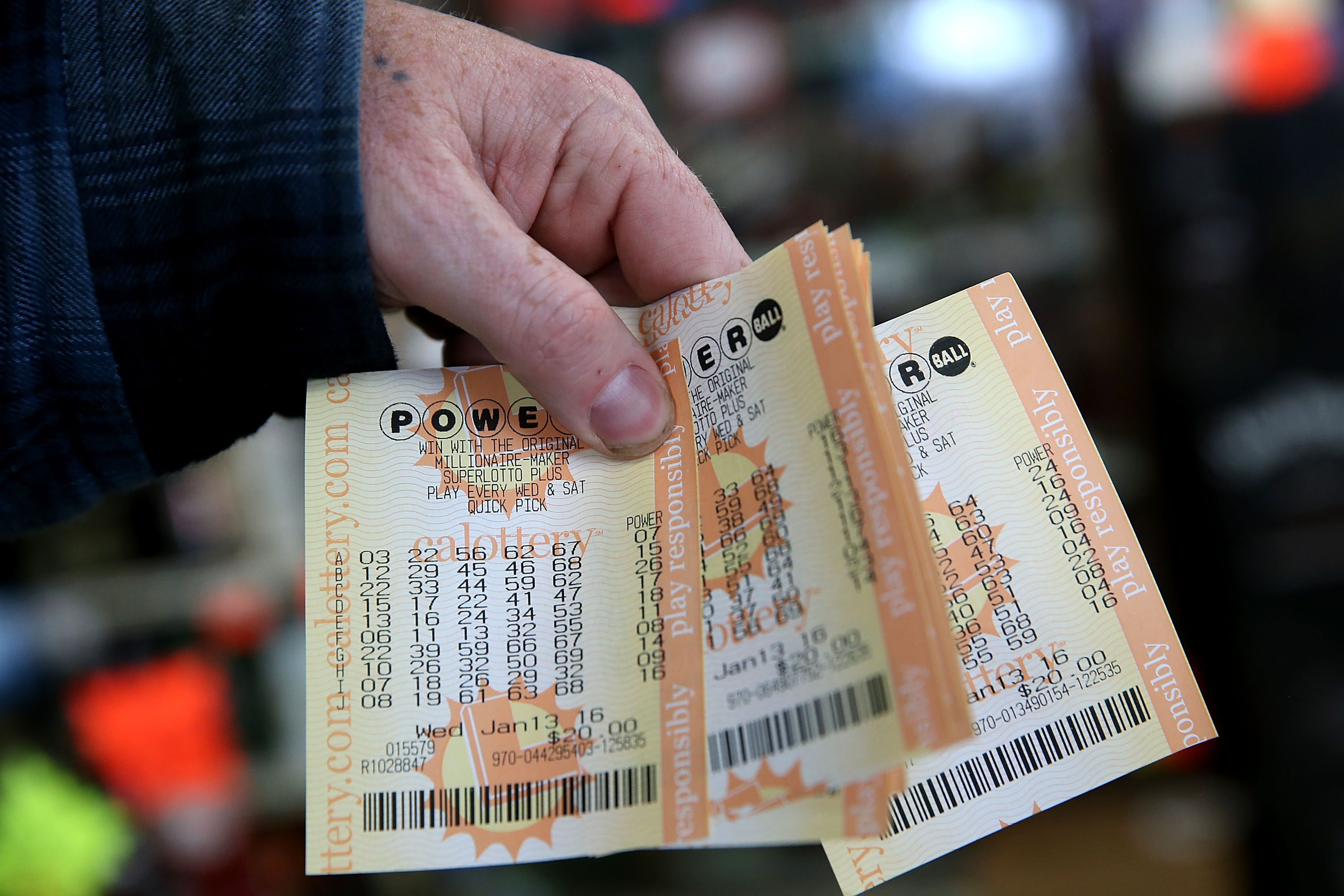 A customer holds a handful of Powerball tickets at Kavanagh Liquors on January 13, 2016 in San Lorenzo, California.