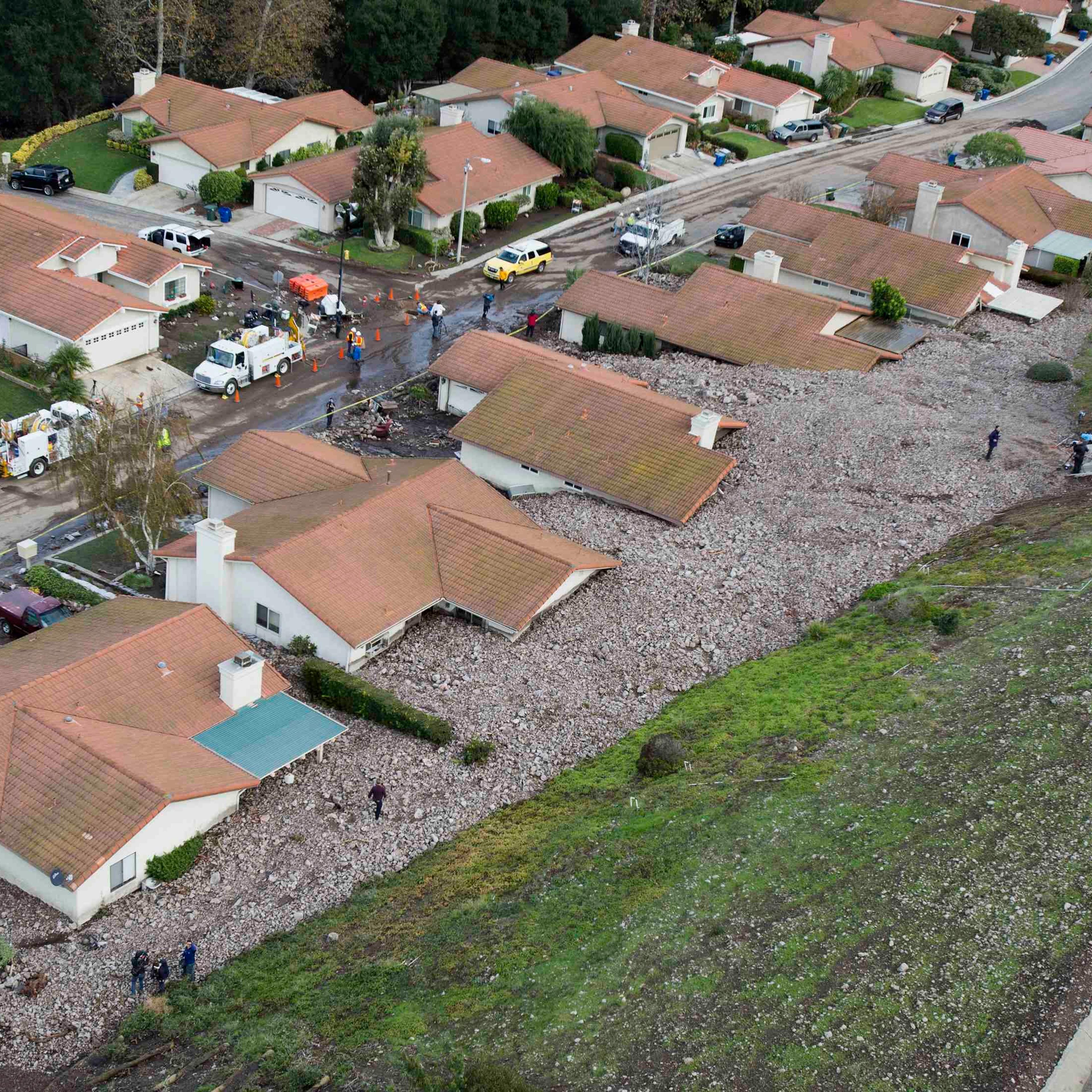 A group of houses are pictured after boulder-strewn rivers of mud swept down hillsides during a winter storm, in Camarillo Springs, California