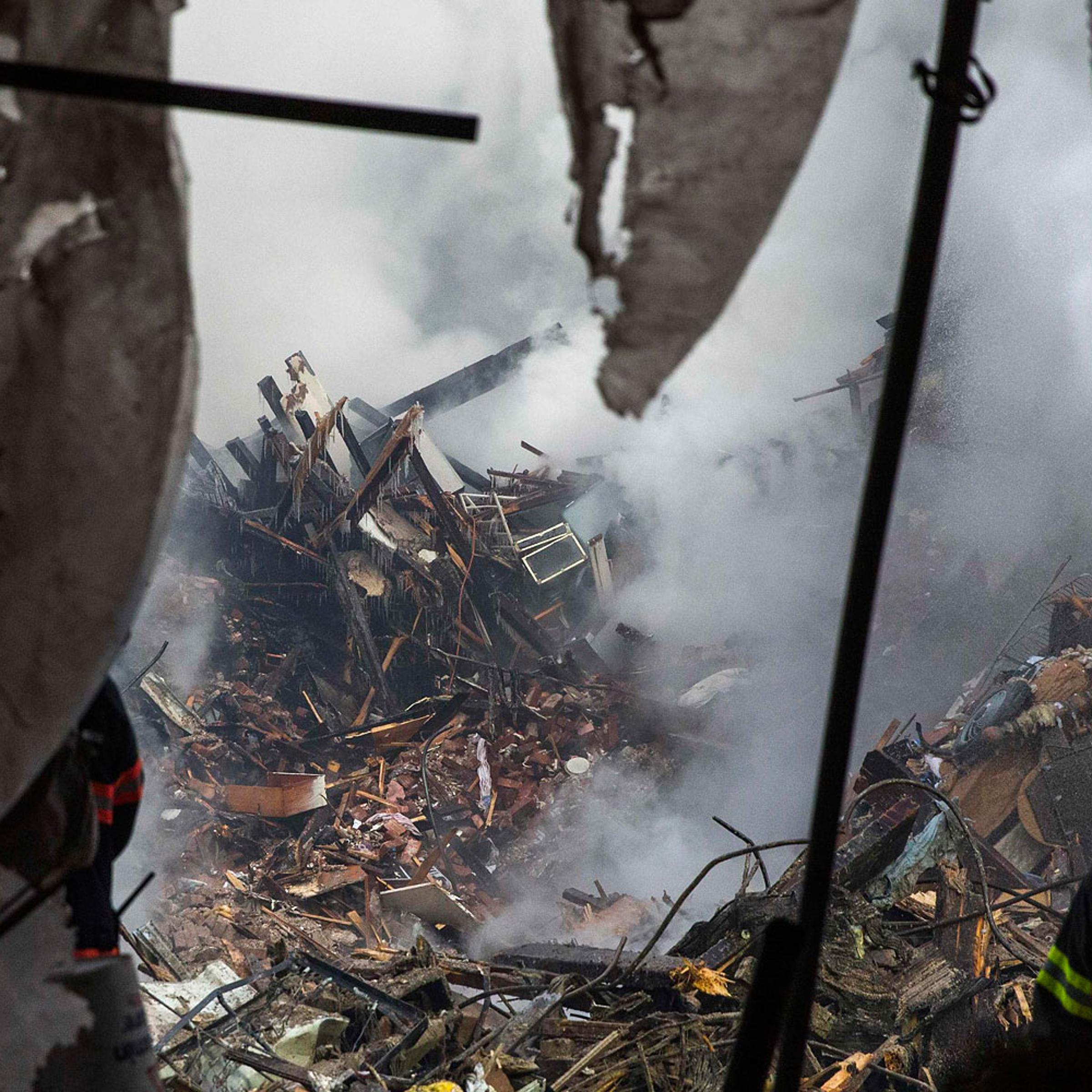 New York City emergency responders search through the rubble at the site of a building explosion in the Harlem section of New York, March 13, 2014.