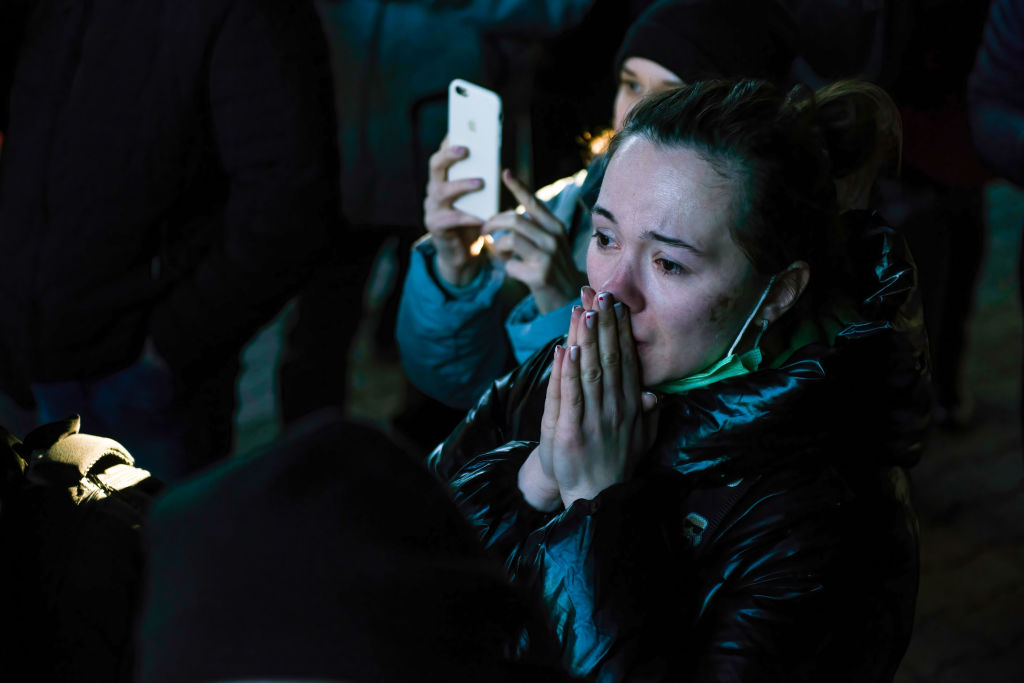 A woman is crying while waiting for her relatives from