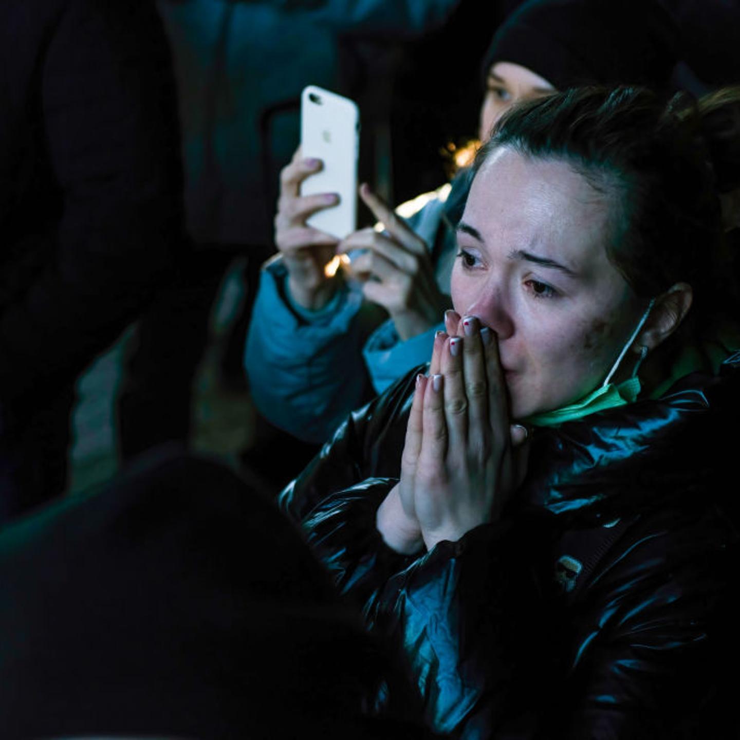 A woman is crying while waiting for her relatives from