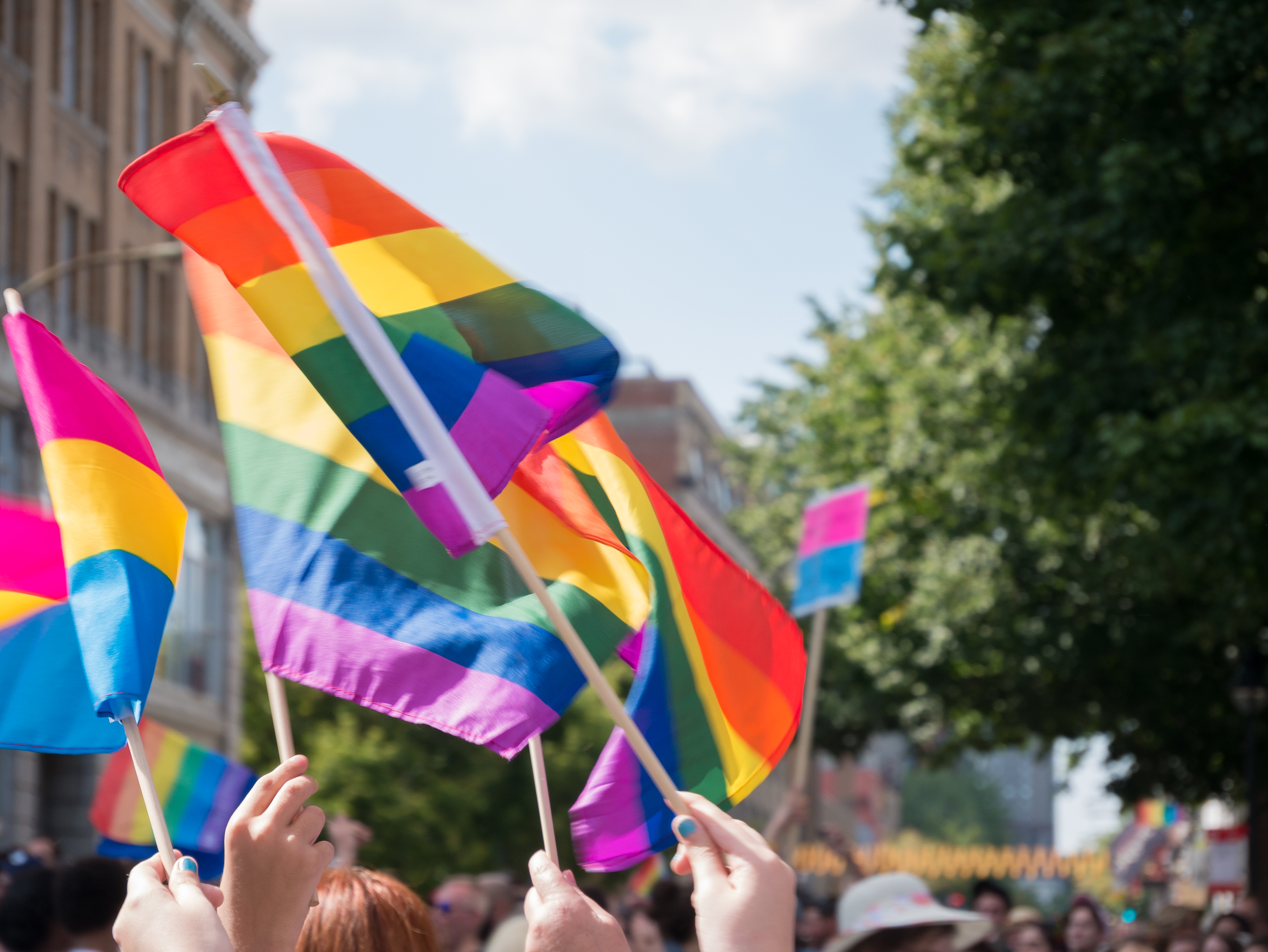 Flags of gay pride float in the air during parade in Montreal, Canada