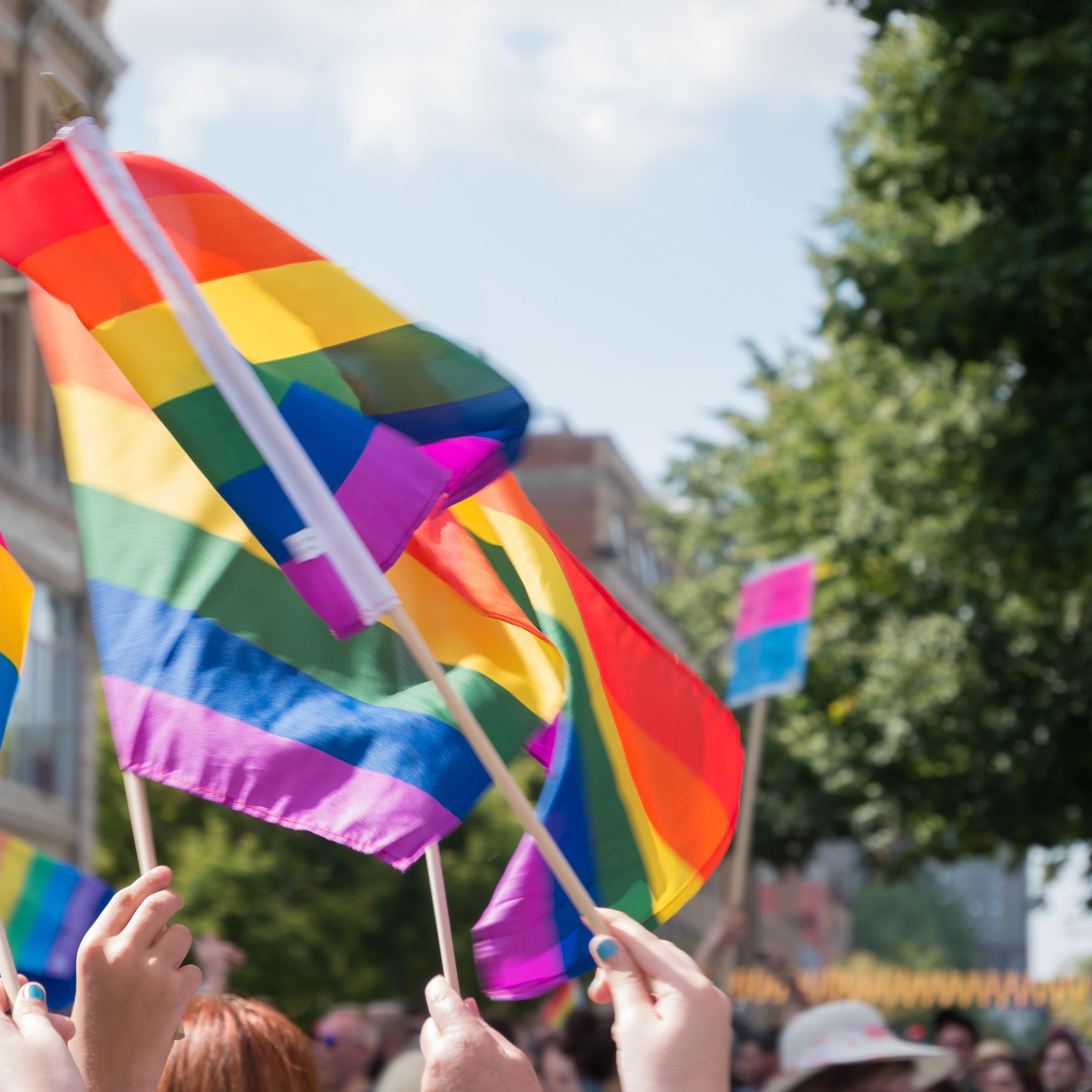 Flags of gay pride float in the air during parade in Montreal, Canada