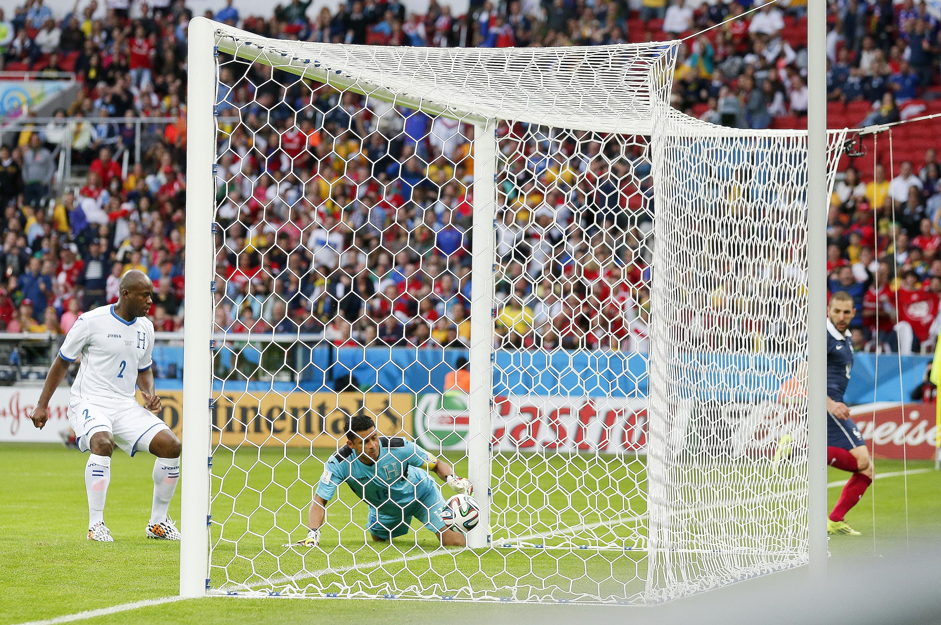 Honduras' goalkeeper Noel Valladares bundles a shot from France's Karim Benzema, far right, into his net for an own goal during the group E World Cup soccer match between France and Honduras at the Estadio Beira-Rio in Porto Alegre, Brazil on June 15, 20