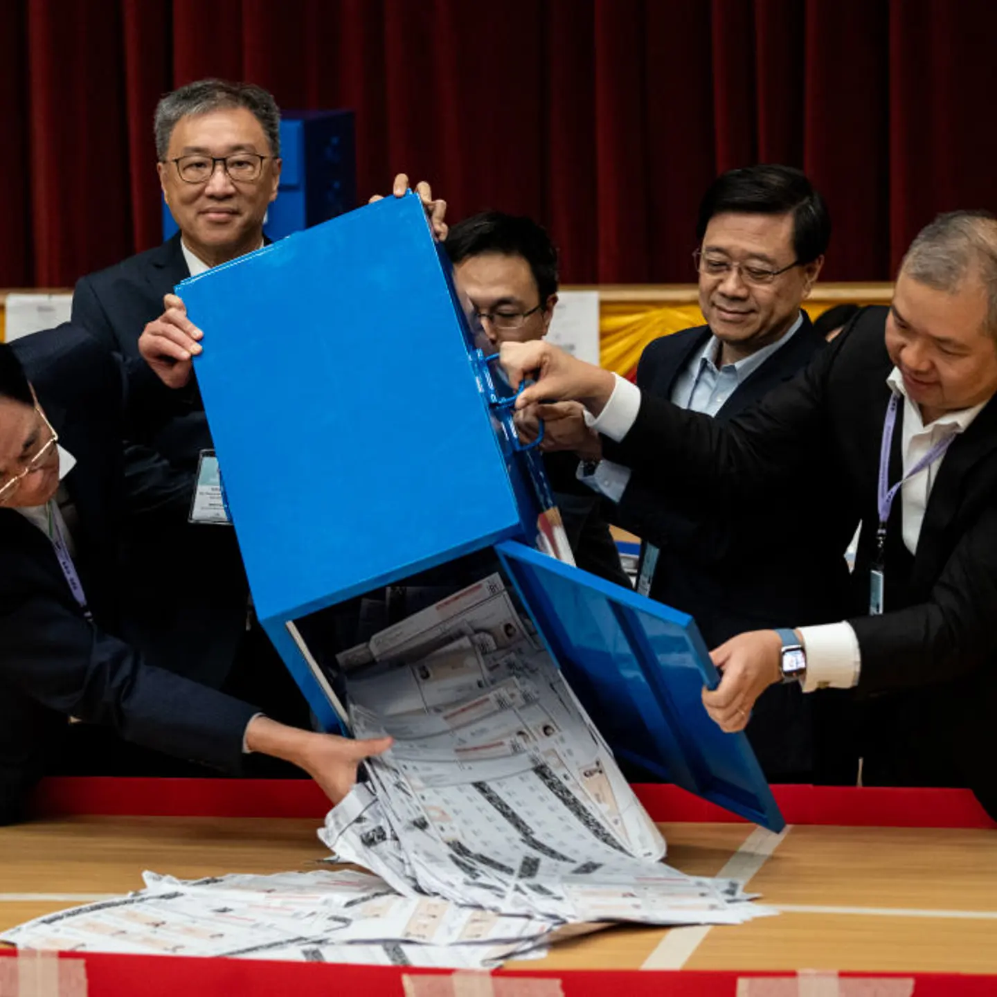 Hong Kong Chief Executive John Lee is helping to pour out votes from the ballot box at a polling station in Hong Kong, China, on Dec. 10, 2023.