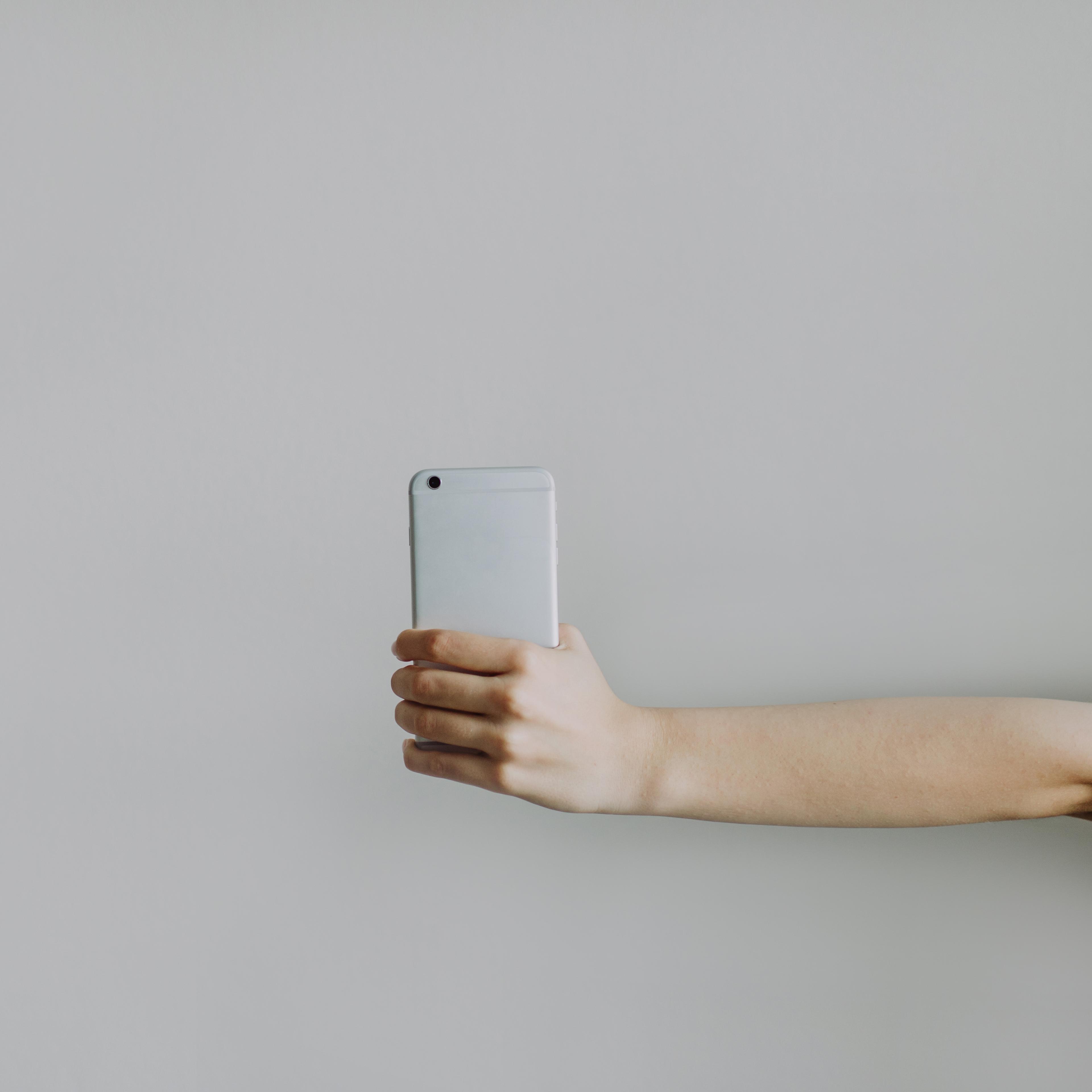 Woman's hand holding a mobile phone