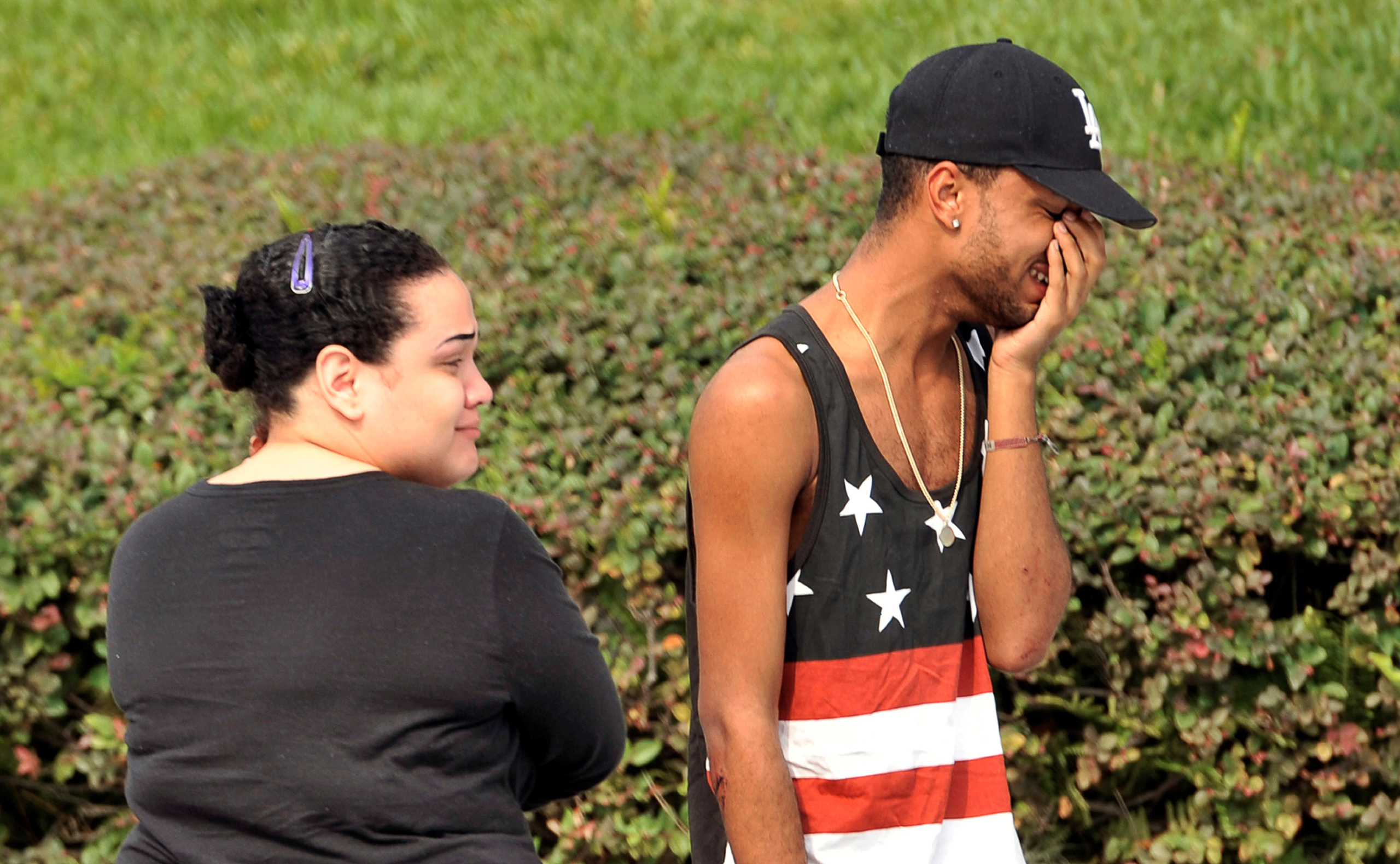 Friends and family members embrace outside the Orlando Police Headquarters during the investigation of a shooting at the Pulse nightclub, where people were killed by a gunman, in Orlando, Florida, U.S June 12, 2016. REUTERS/Steve Nesius - RTX2FRIU