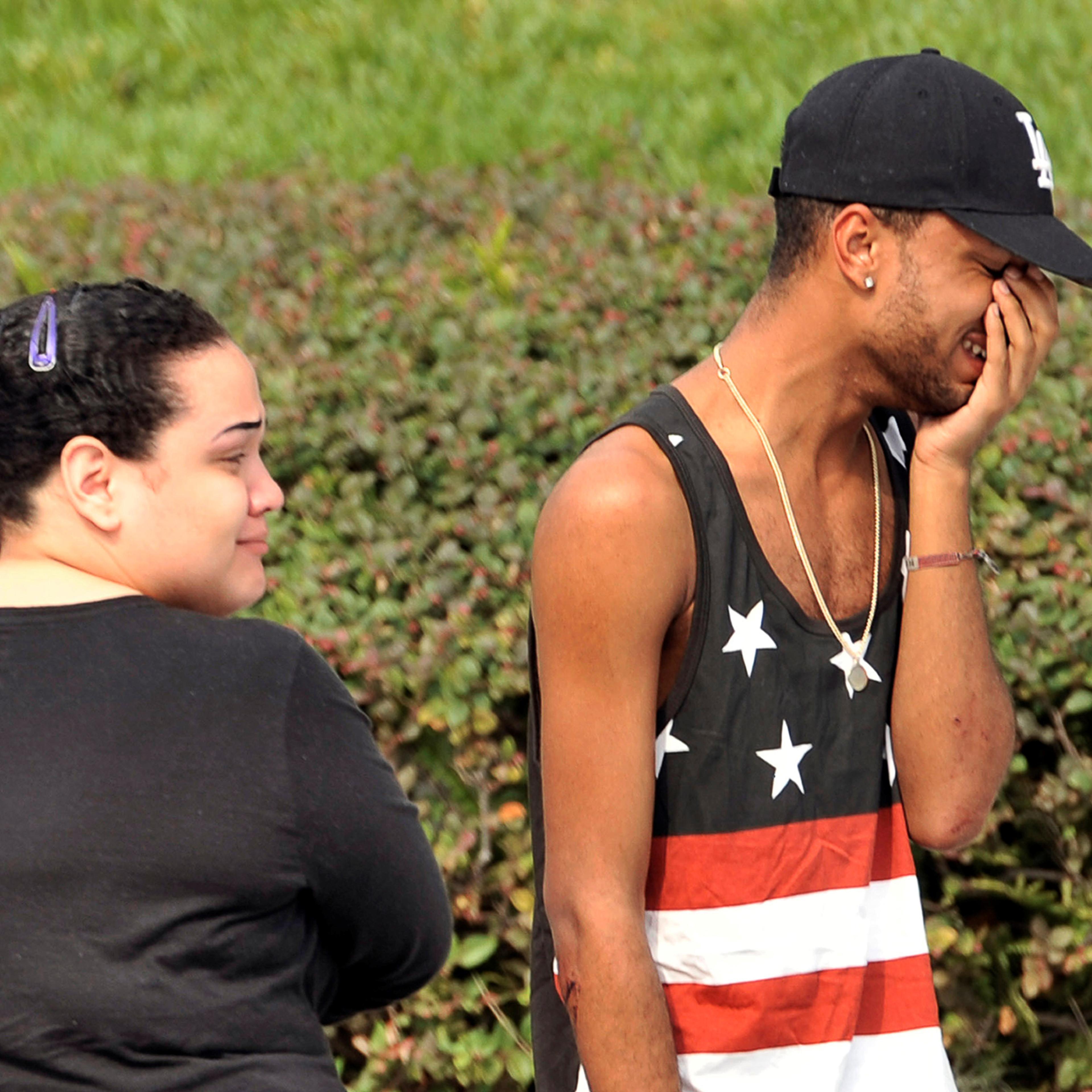 Friends and family members embrace outside the Orlando Police Headquarters during the investigation of a shooting at the Pulse nightclub, where people were killed by a gunman, in Orlando, Florida, U.S June 12, 2016. REUTERS/Steve Nesius - RTX2FRIU