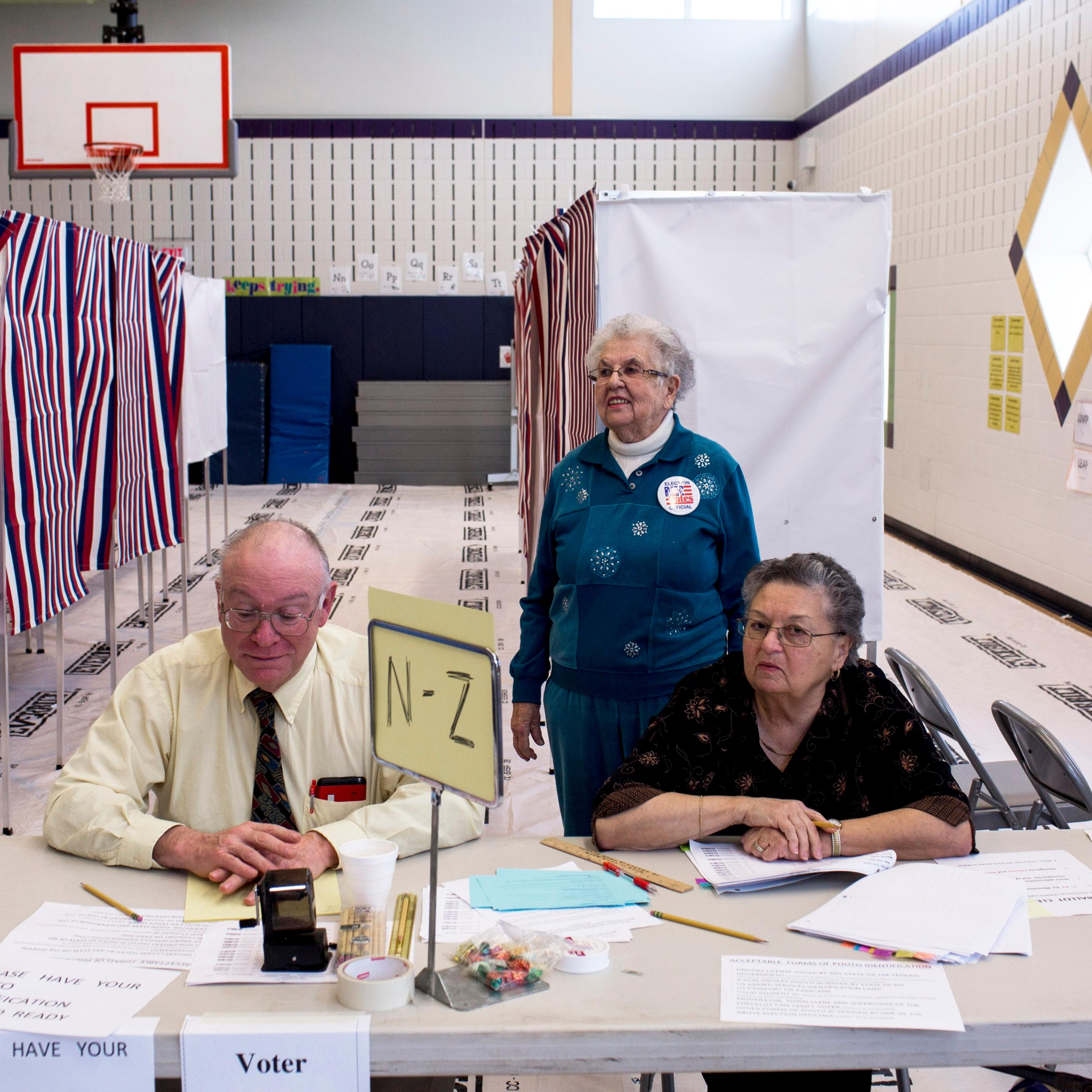 New Hampshire Volunteers staff a polling station at Windham High School on Feb. 9, 2016, in Windham, N.H.