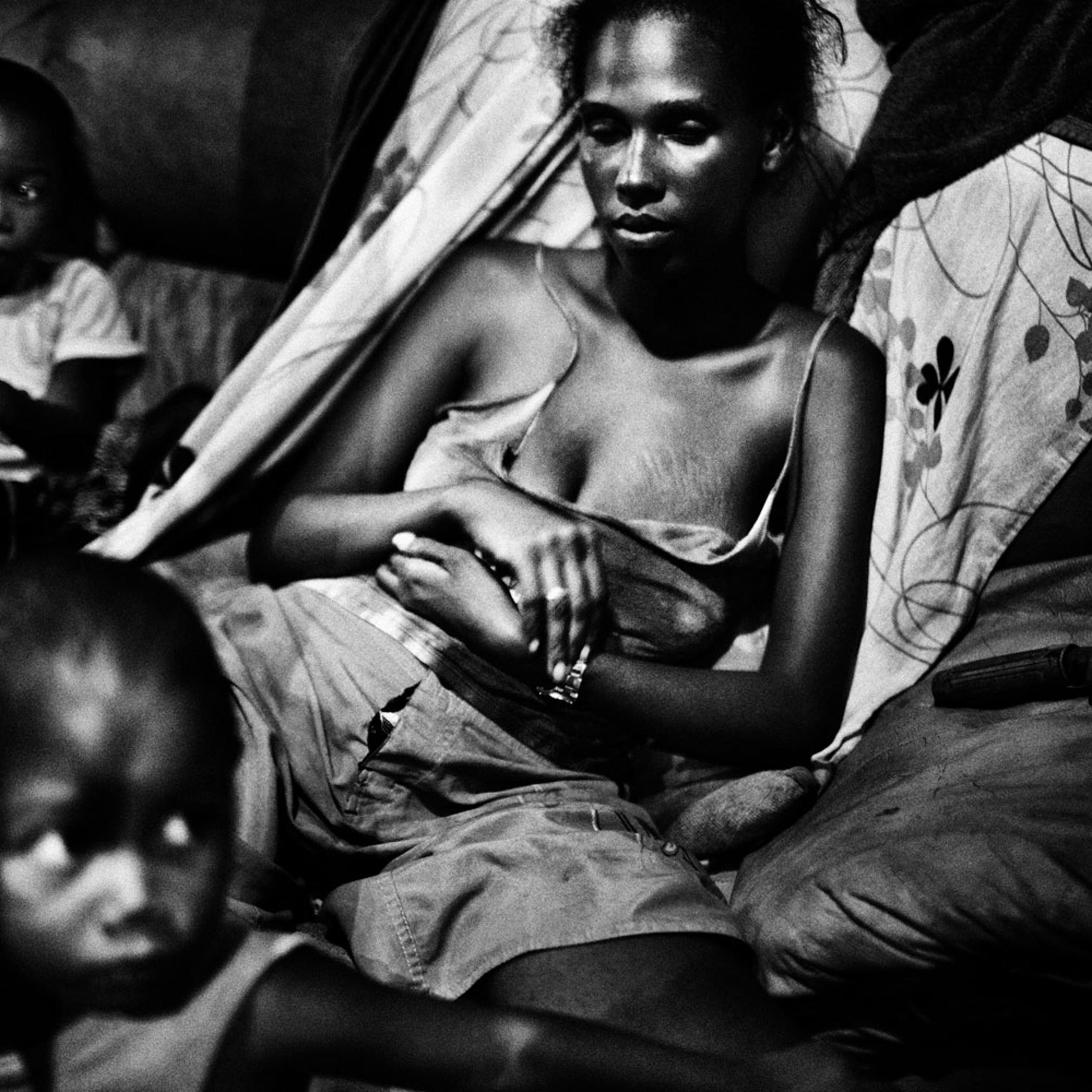 Sebastian Liste, The Brazilian Far West<br><br>Salvador de Bahia, Brazil. Melanie, 22, with her two sons in a small shack in an abandoned chocolate factory. In spite of the extreme conditions, this factory in ruins has become a home for her family.