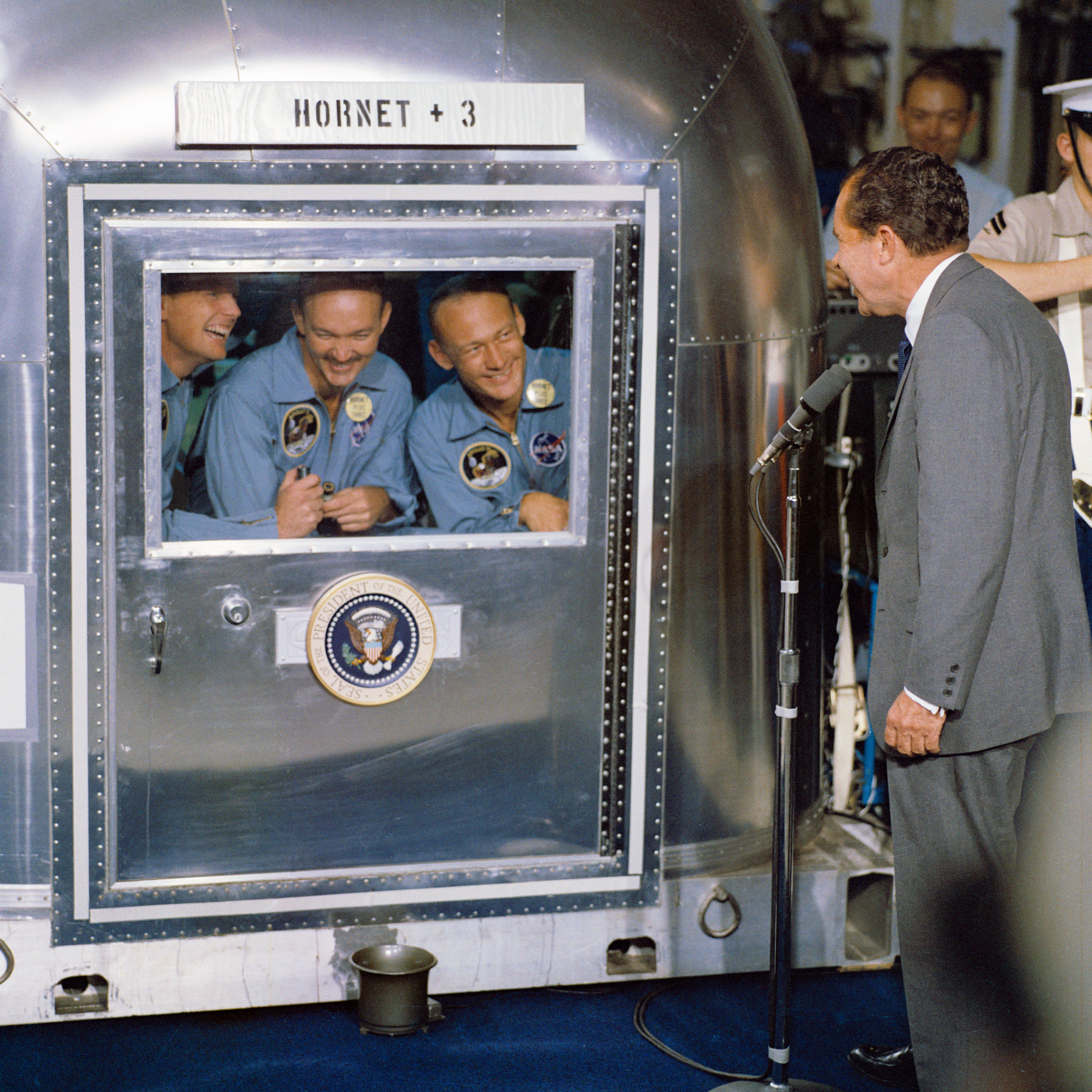 President Nixon greeted Apollo 11 astronauts Neil Armstrong, Mike Collins and Buzz Aldrin, who went immediately into medical quarantine after their return from the moon on July 24, 1969