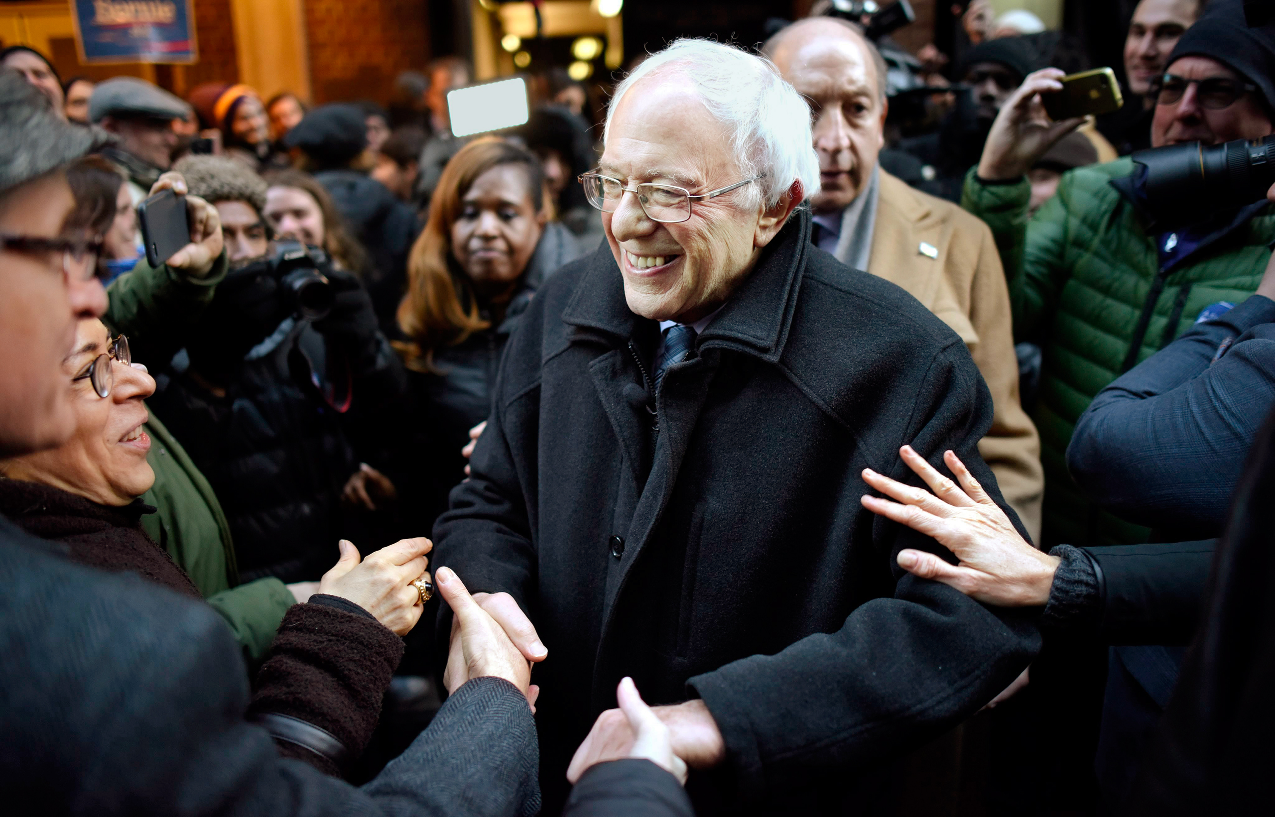 United States Democratic presidential candidate Senator Bernie Sanders (C), of Vermont, shakes hands with supporters following a speech about Wall Street and his plans for new financial regulations at Town Hall in New York, New York, USA, 05 January 2016