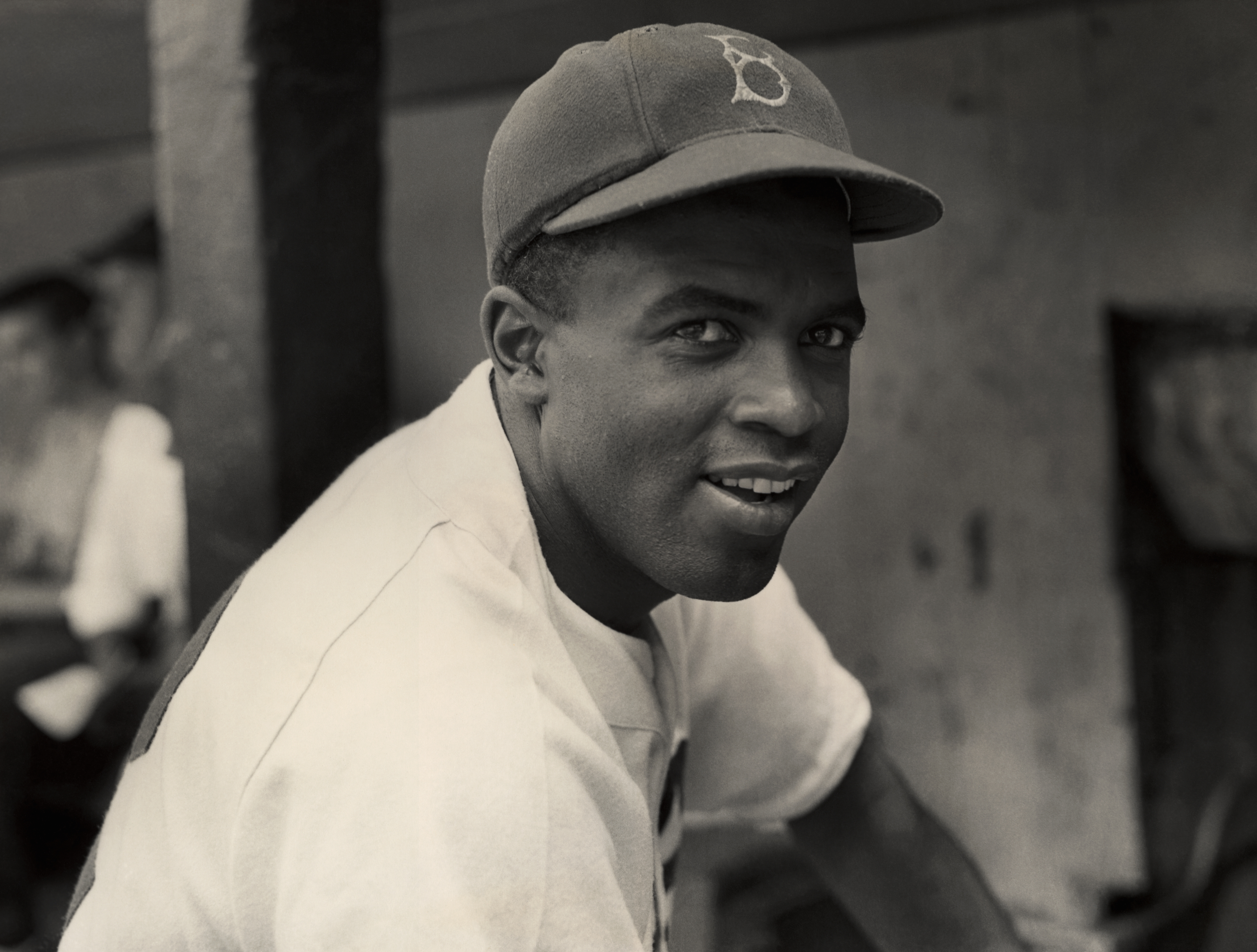 A portrait of the Brooklyn Dodgers' infielder Jackie Robinson in uniform.