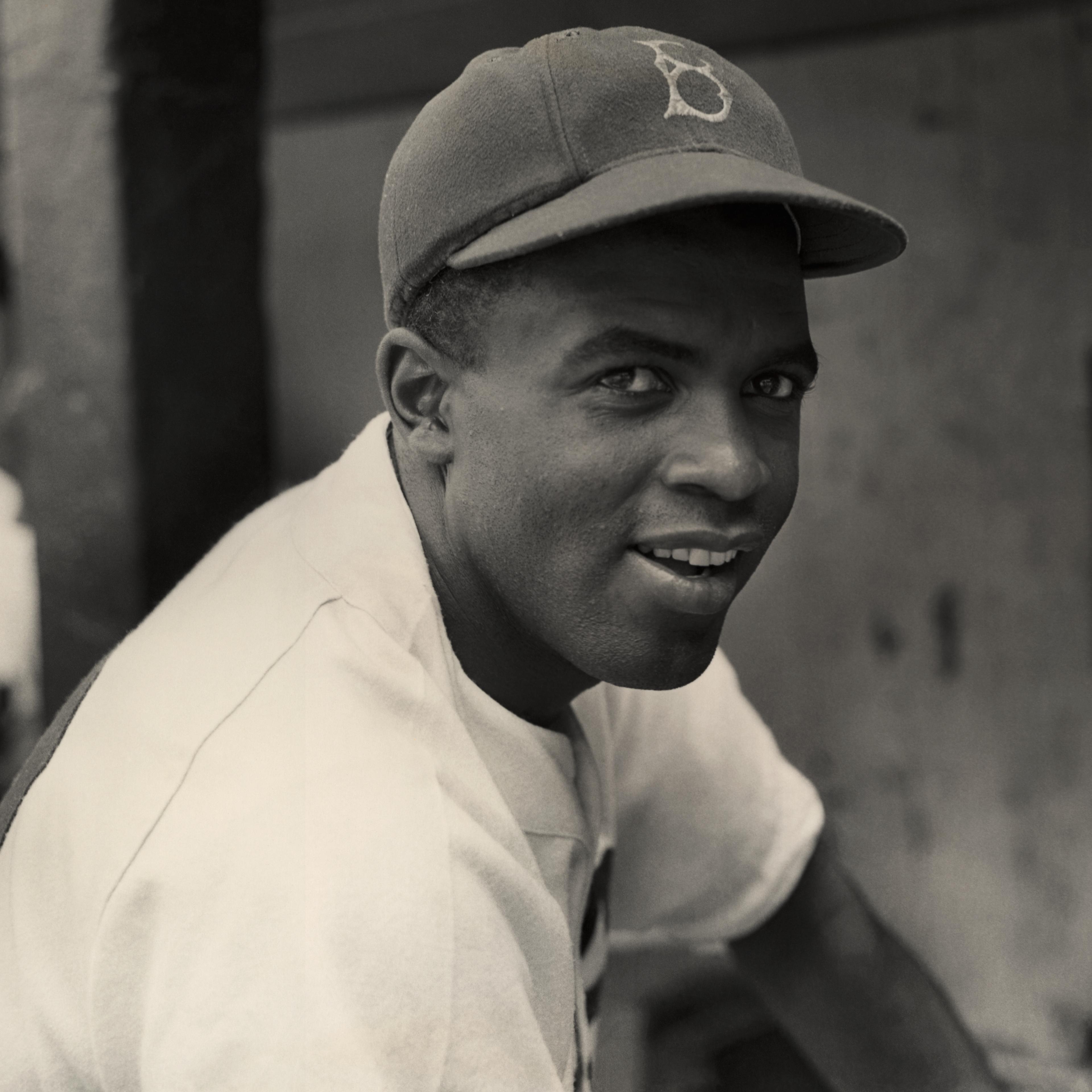A portrait of the Brooklyn Dodgers' infielder Jackie Robinson in uniform.