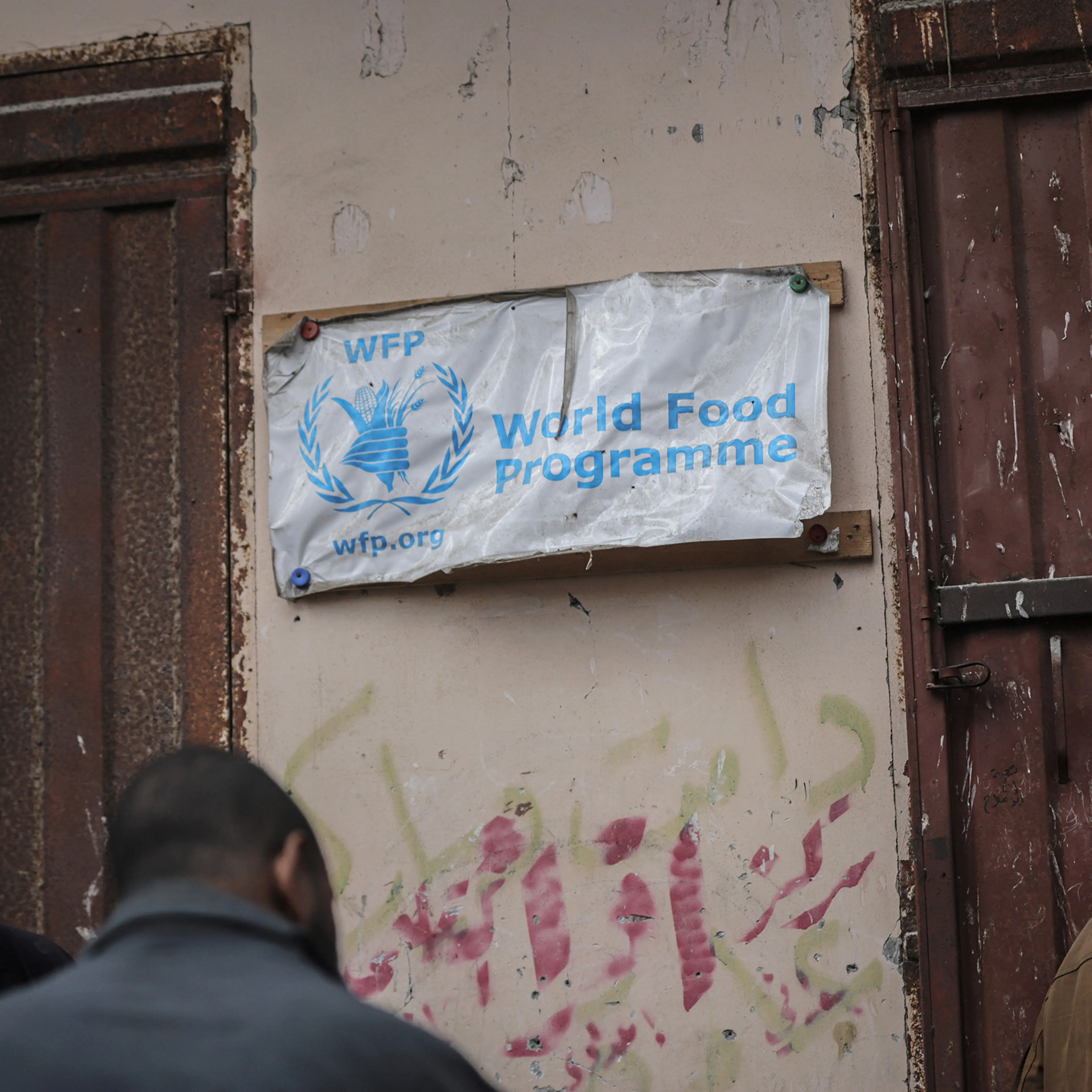 A sign for the World Food Programme outside a United Nations Relief and Works Agency (UNRWA) food aid warehouse in Deir Al-balah, Gaza, on Jan. 23, 2025.