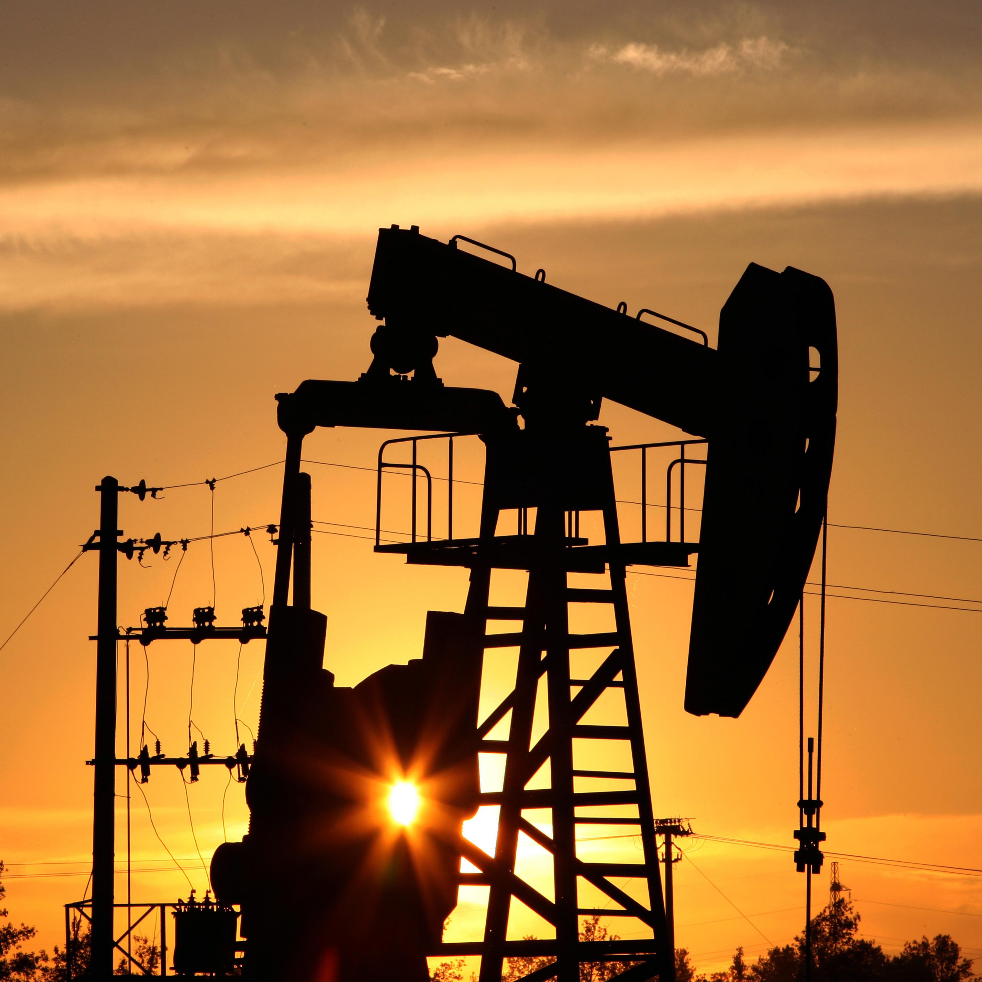 A CNPC 'nodding donkey' oil pump is seen at sunset in an oilfield outside Daqing, Heilongjiang province, China.