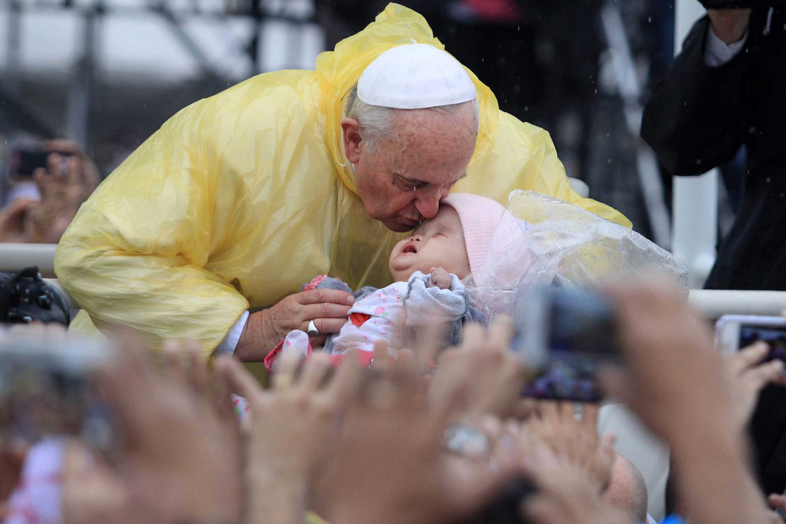 Pope Francis aboard his popemobile kisses a Filipino baby prior to his mass in Quirino grandstand, Manila, Jan. 18, 2015.