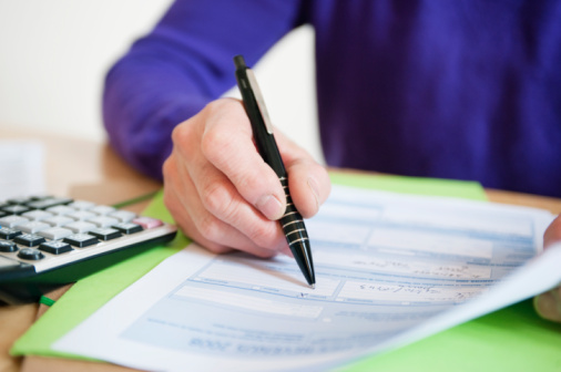 man-completing-tax-form