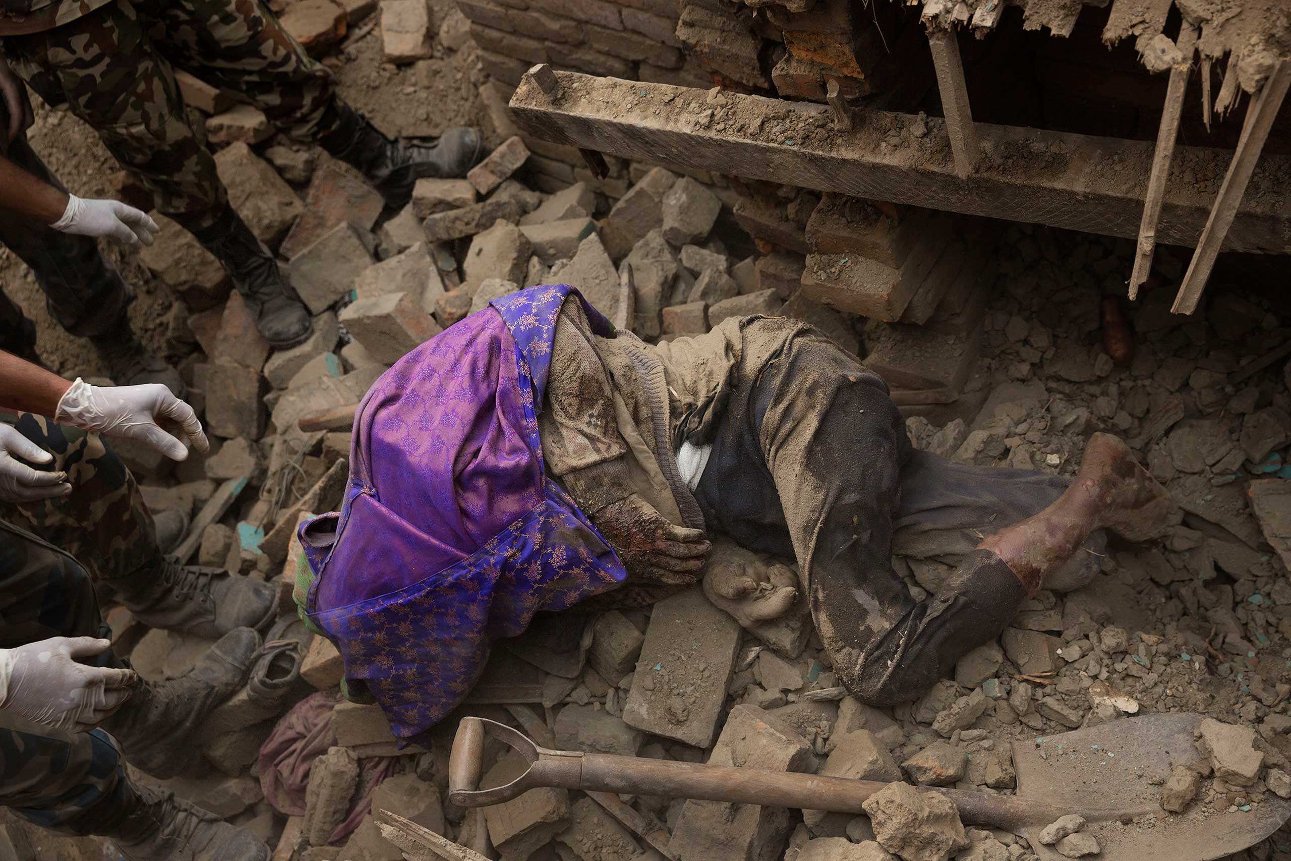 Nepal earthquake. Bhaktapur. A city near Katmandu. People reclaiming their possessions from the wreckage. A man who had been buried and died being pulled out of the wreckage by there Nepali Army rescue team. Sculpture of elephant in ruins of an ancient, 