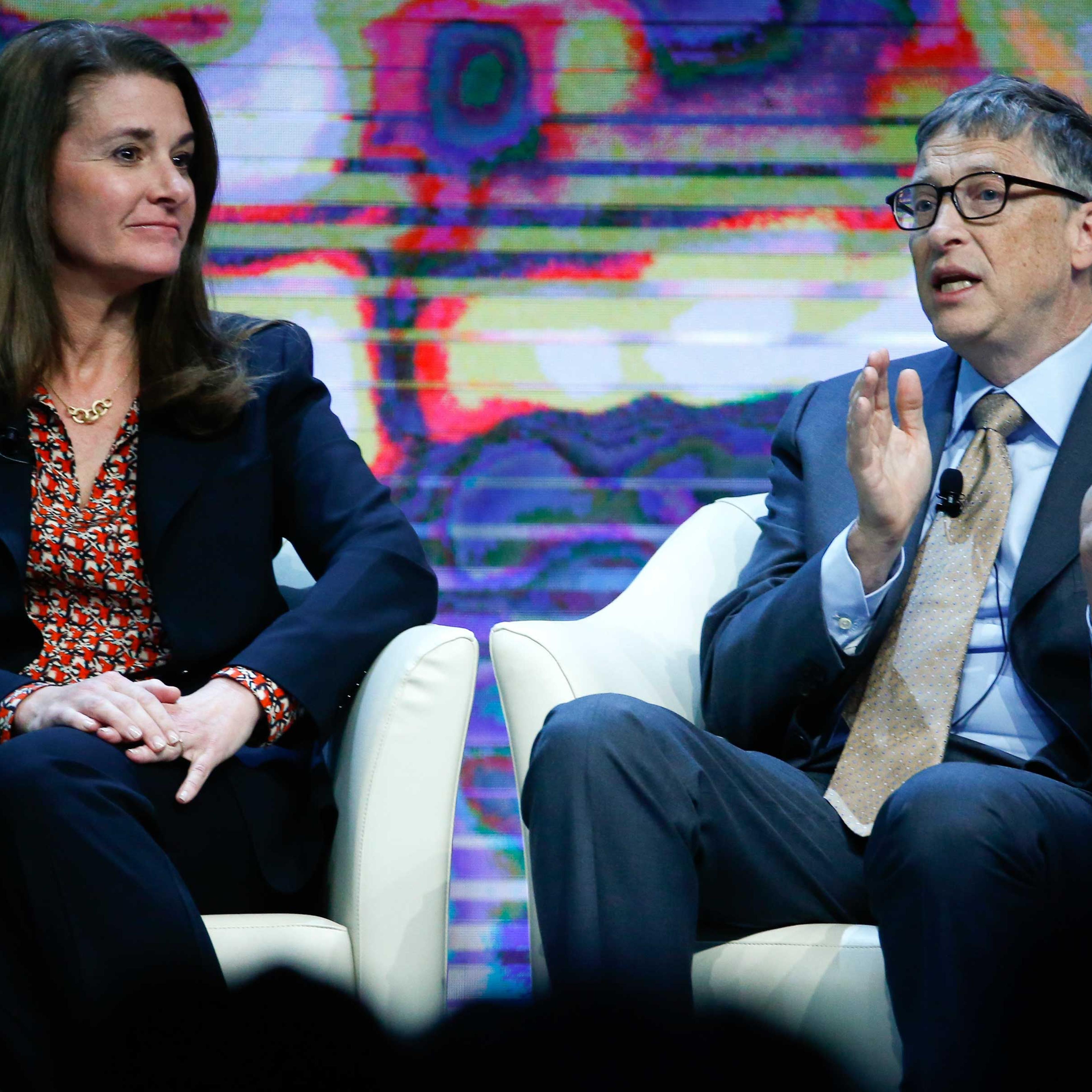 Bill Gates, Co-Chair of the Bill & Melinda Gates Foundation gestures next to his wife Melinda French Gates during the session 'Sustainable Development: A Vision for the Future' in the Swiss mountain resort of Davos