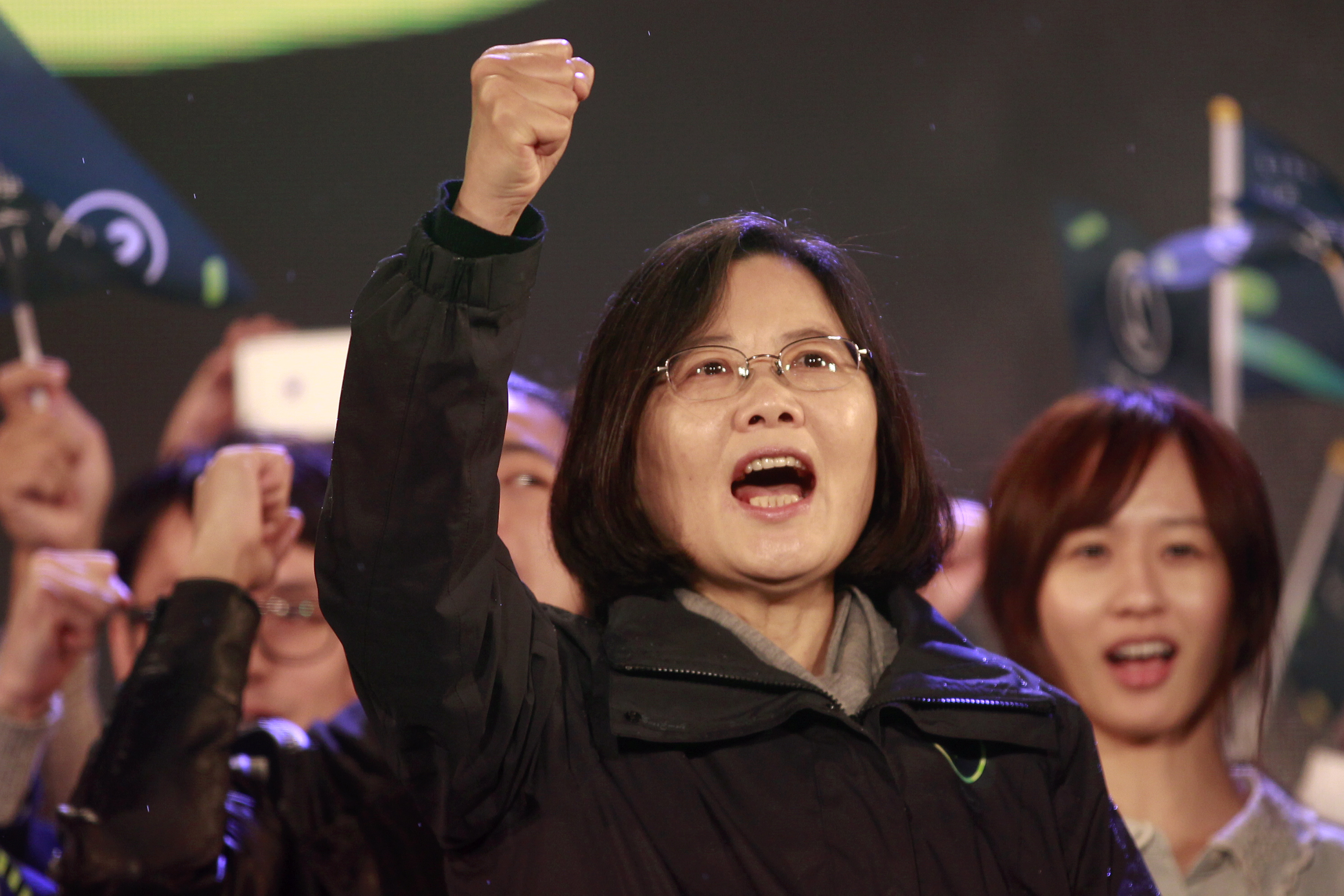 Taiwan's Democratic Progressive Party Chairperson and presidential candidate Tsai Ing-wen shouts slogans from the stage during a final campaign rally ahead of the elections in Taipei