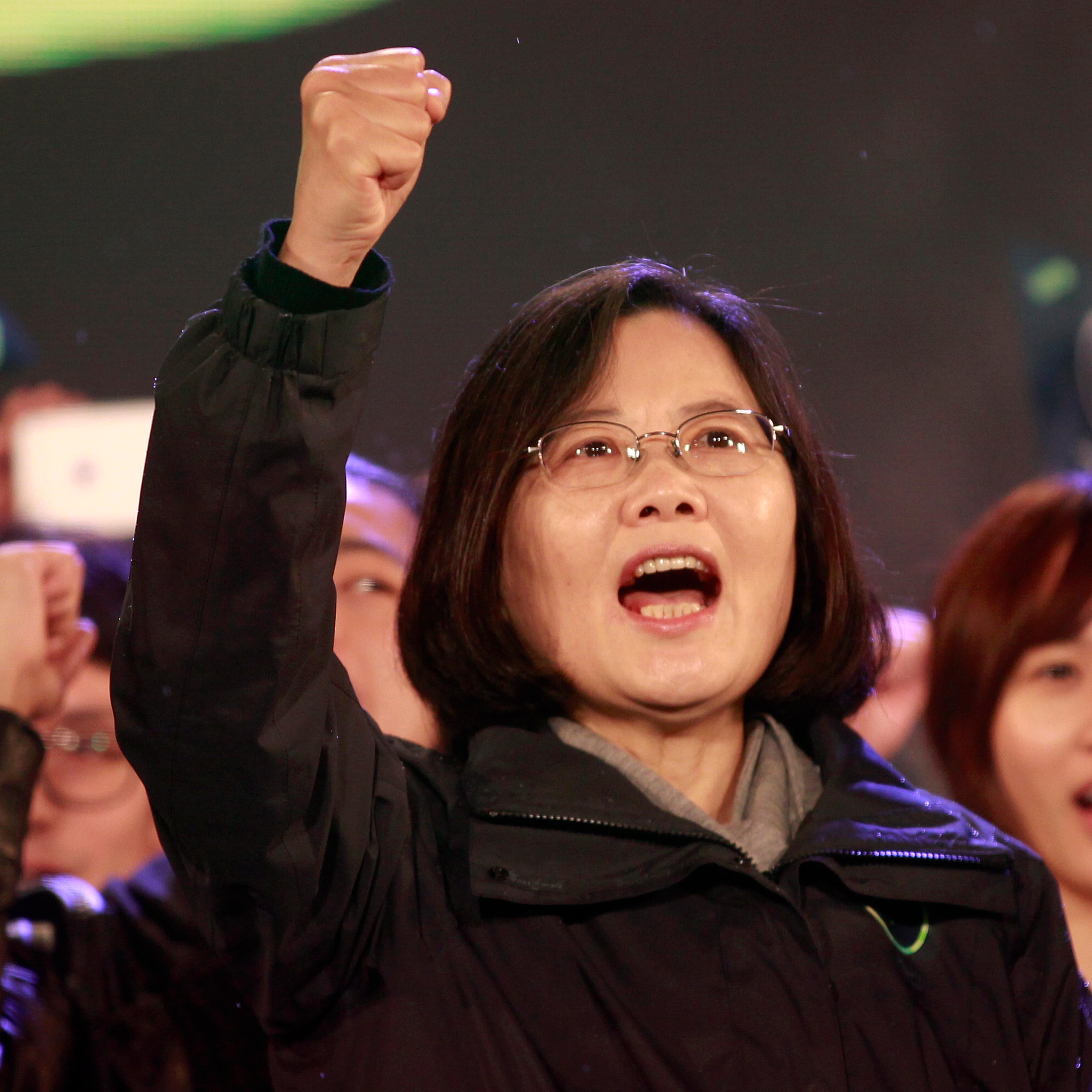 Taiwan's Democratic Progressive Party Chairperson and presidential candidate Tsai Ing-wen shouts slogans from the stage during a final campaign rally ahead of the elections in Taipei