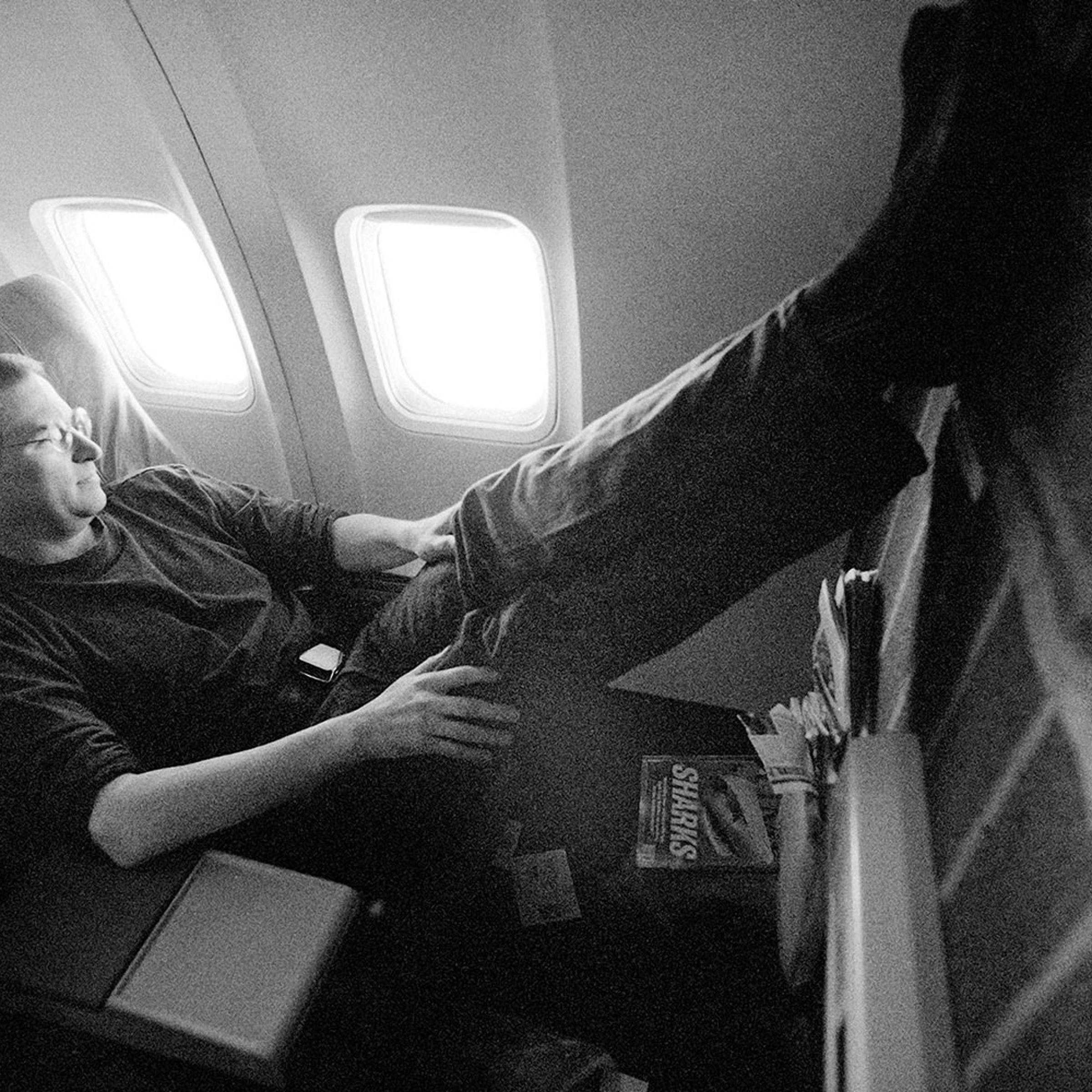 Jobs rests on a flight to the Macworld Expo in Boston in 1997, the year he took back the reins at Apple after a 12-year hiatus.