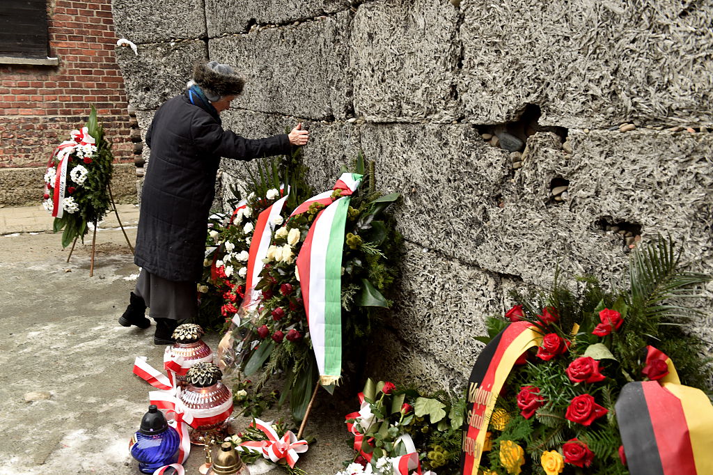 Survivors lay wreaths at the Wall of Death during the 70th anniversary of the liberation of the Nazi German concentration and extermination camp, Auschwitz-Birkenau in Aushwitz on Jan. 27, 2015.
